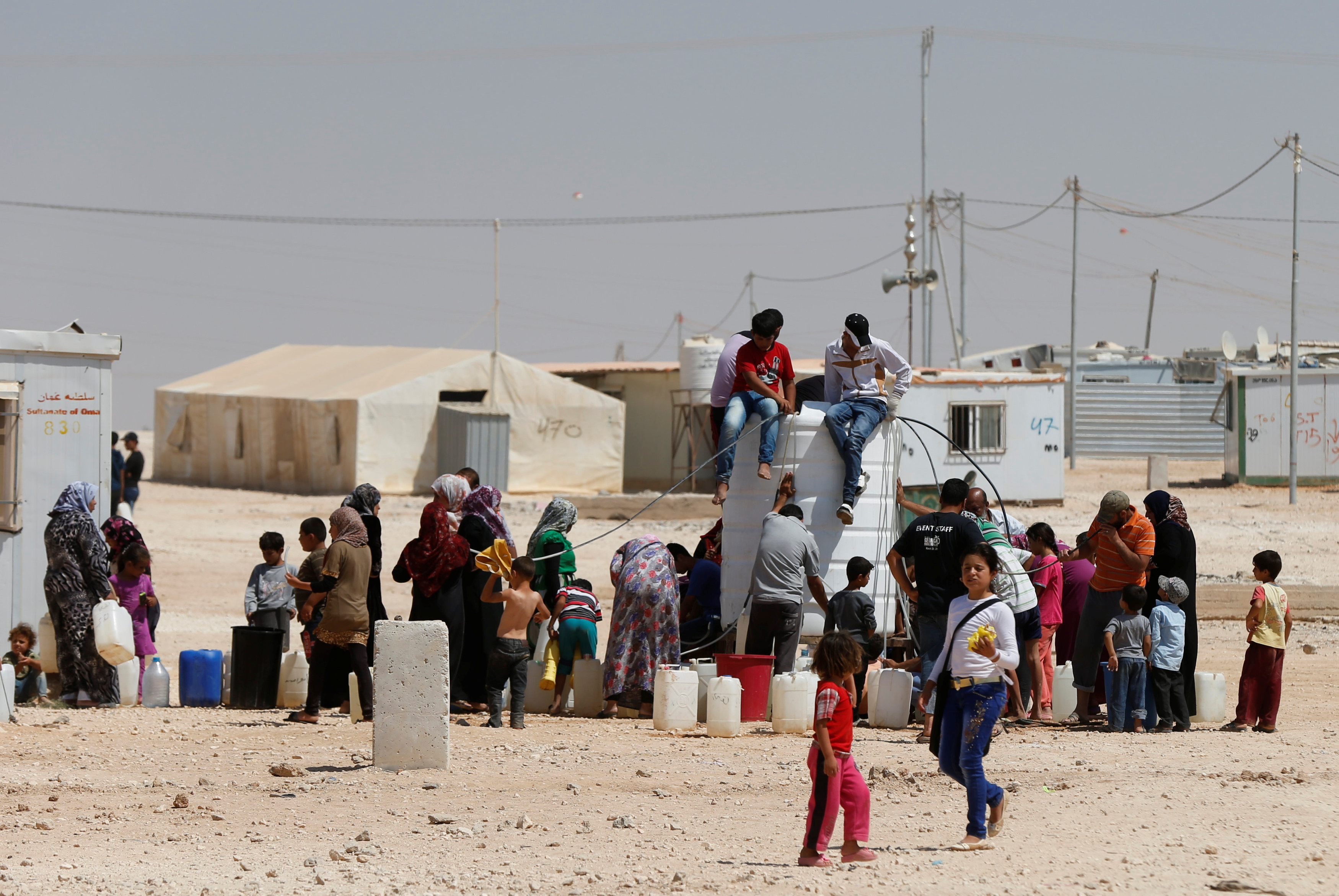 Syrian refugees collect water at the Zaatari refugee camp in Mafraq, Jordan, August 18, 2016