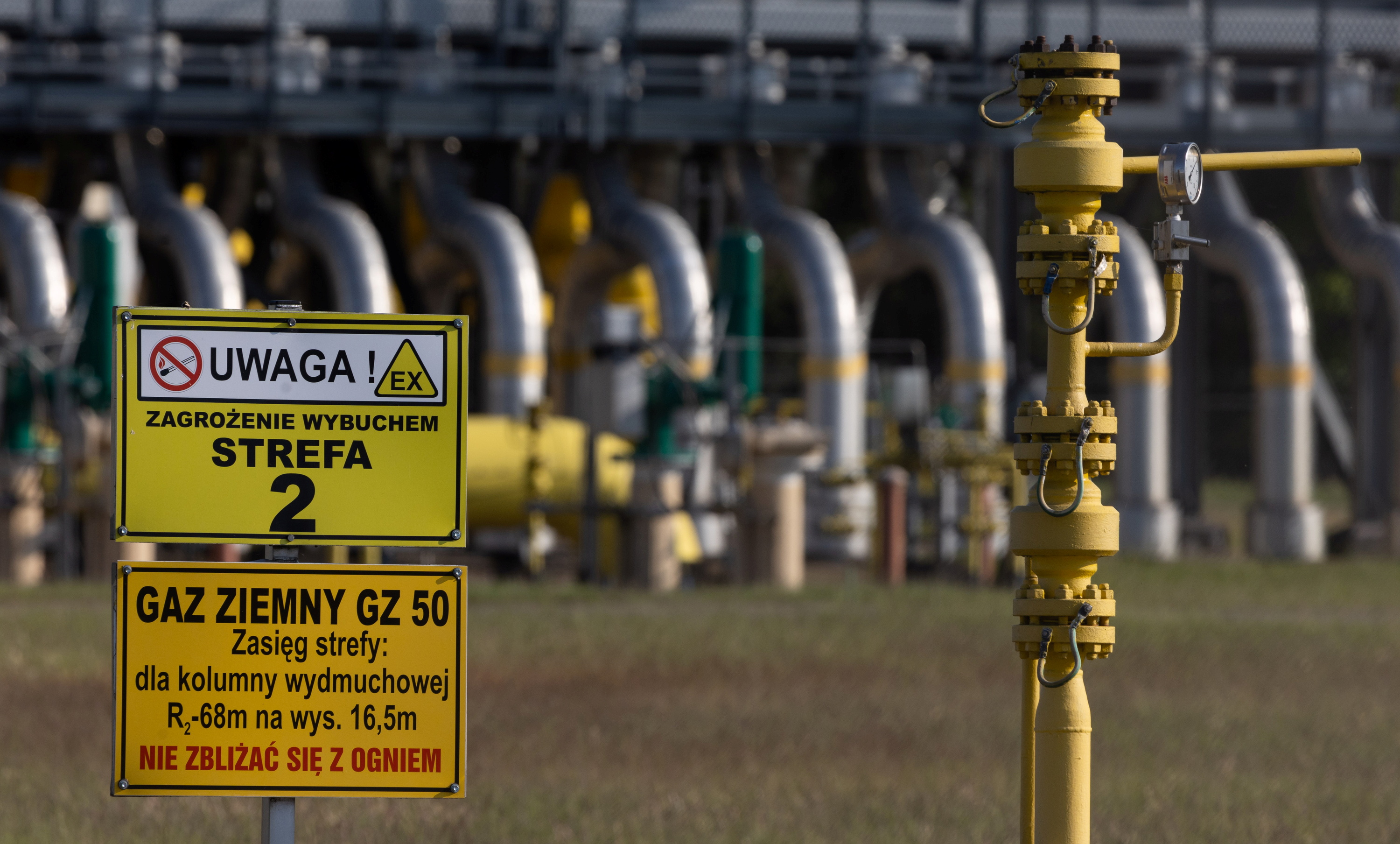 Warning signs are pictured in front of a gas compressor station on a part of the Polish section of the Yamal pipeline that links Russia with western Europe