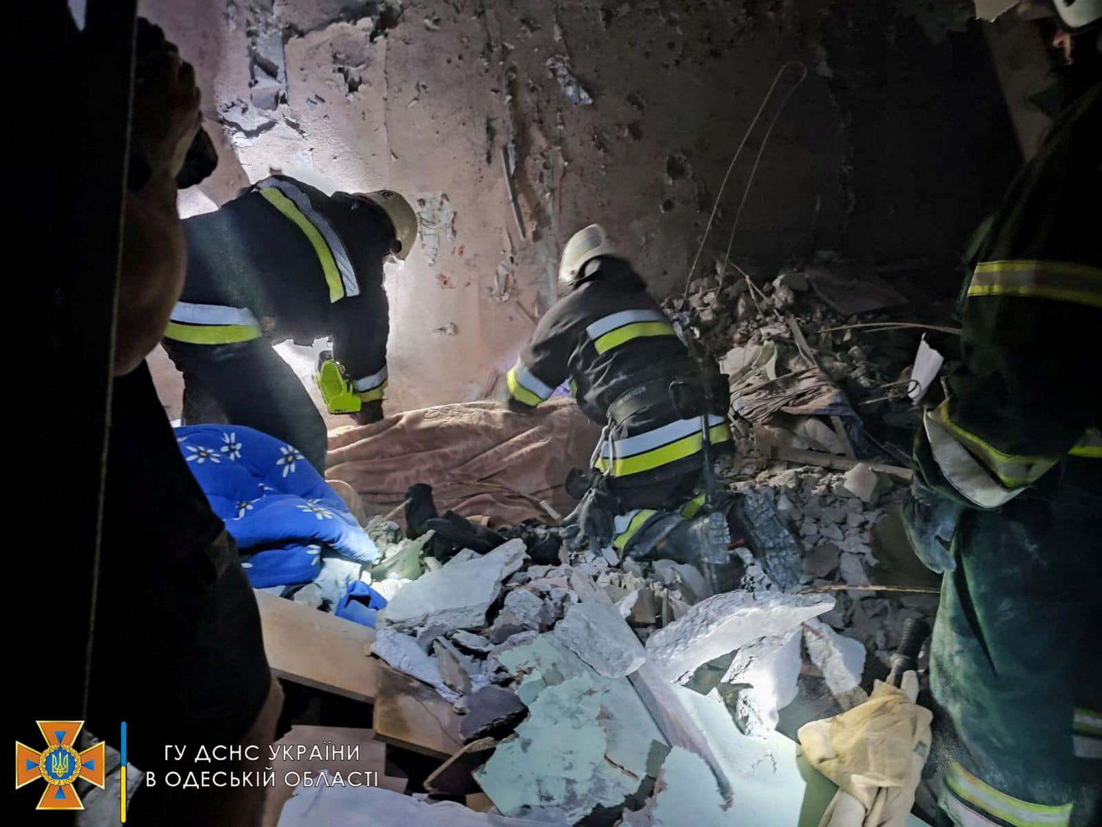 An image released by the State Emergency Services of Ukraine shows rescue workers at the scene of a missile raid at a location in Odesa region, Ukraine [Reuters]