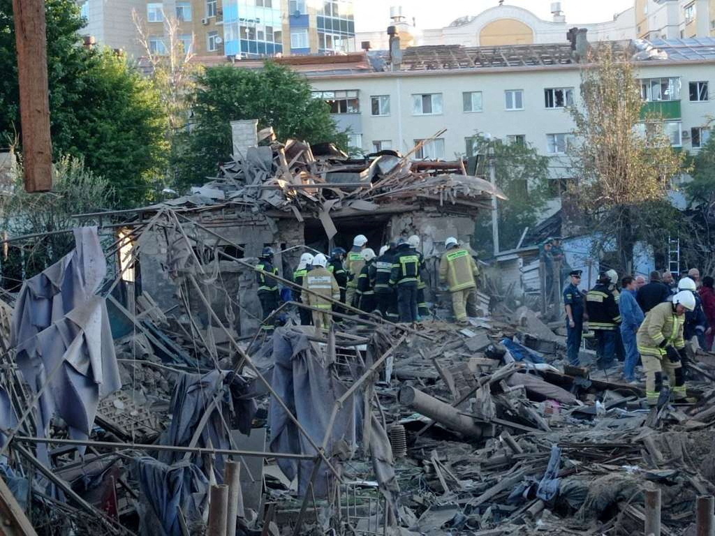 Rescue specialists work at the site of a destroyed residential building after the blasts in Belgorod, Russia July 3, 2022.