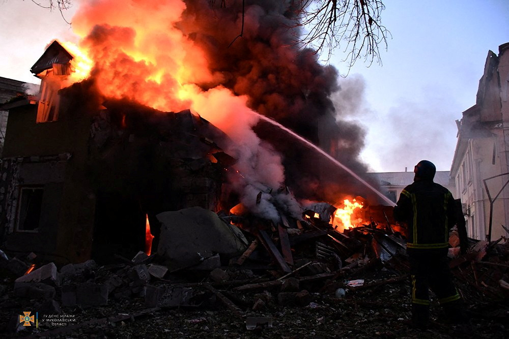 A firefighter works at a site of a residential building damaged by a Russian military raid, as Russia’s attack on Ukraine continues, in Mykolaiv, Ukraine [Reuters]