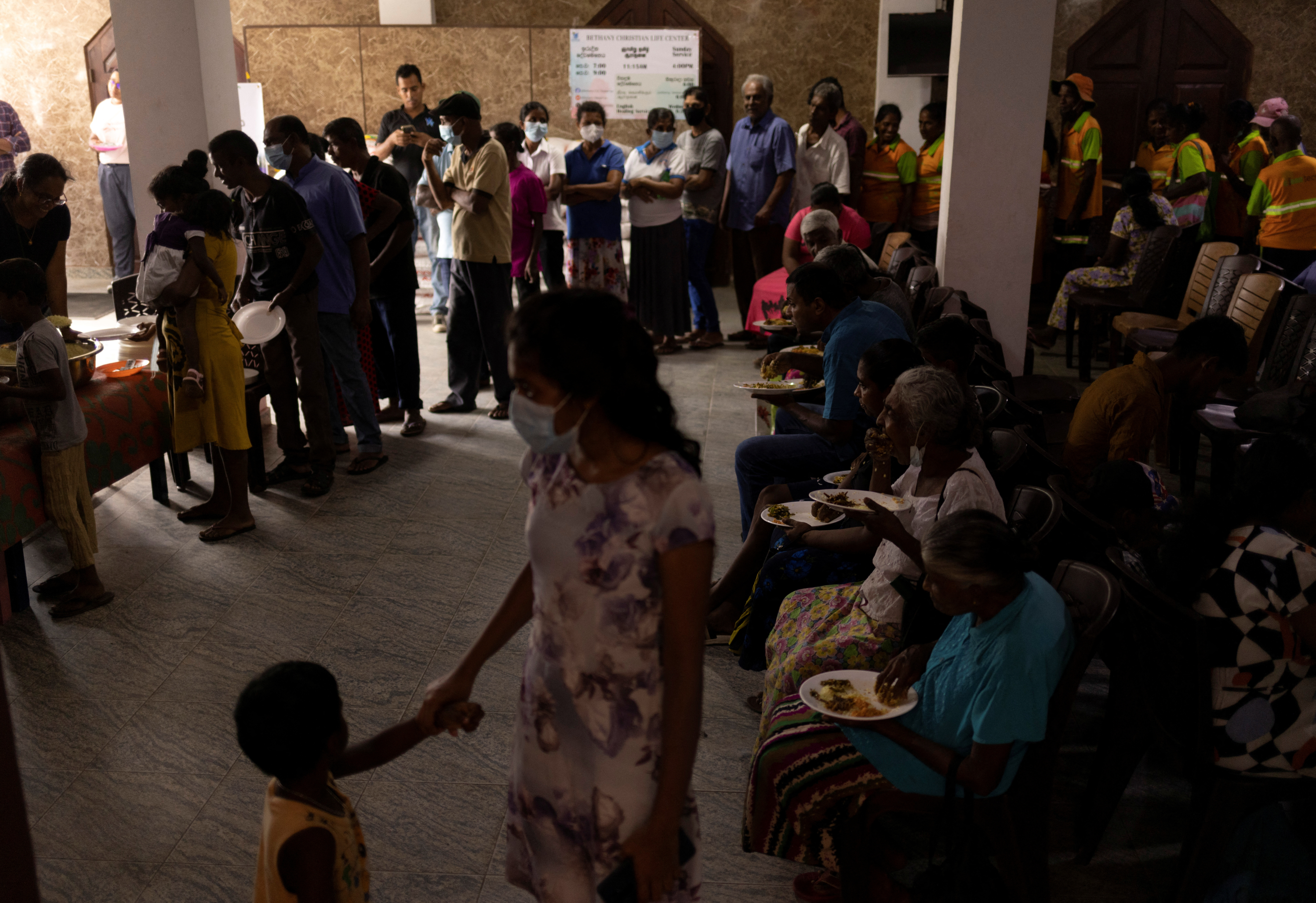 People eat at a community kitchen