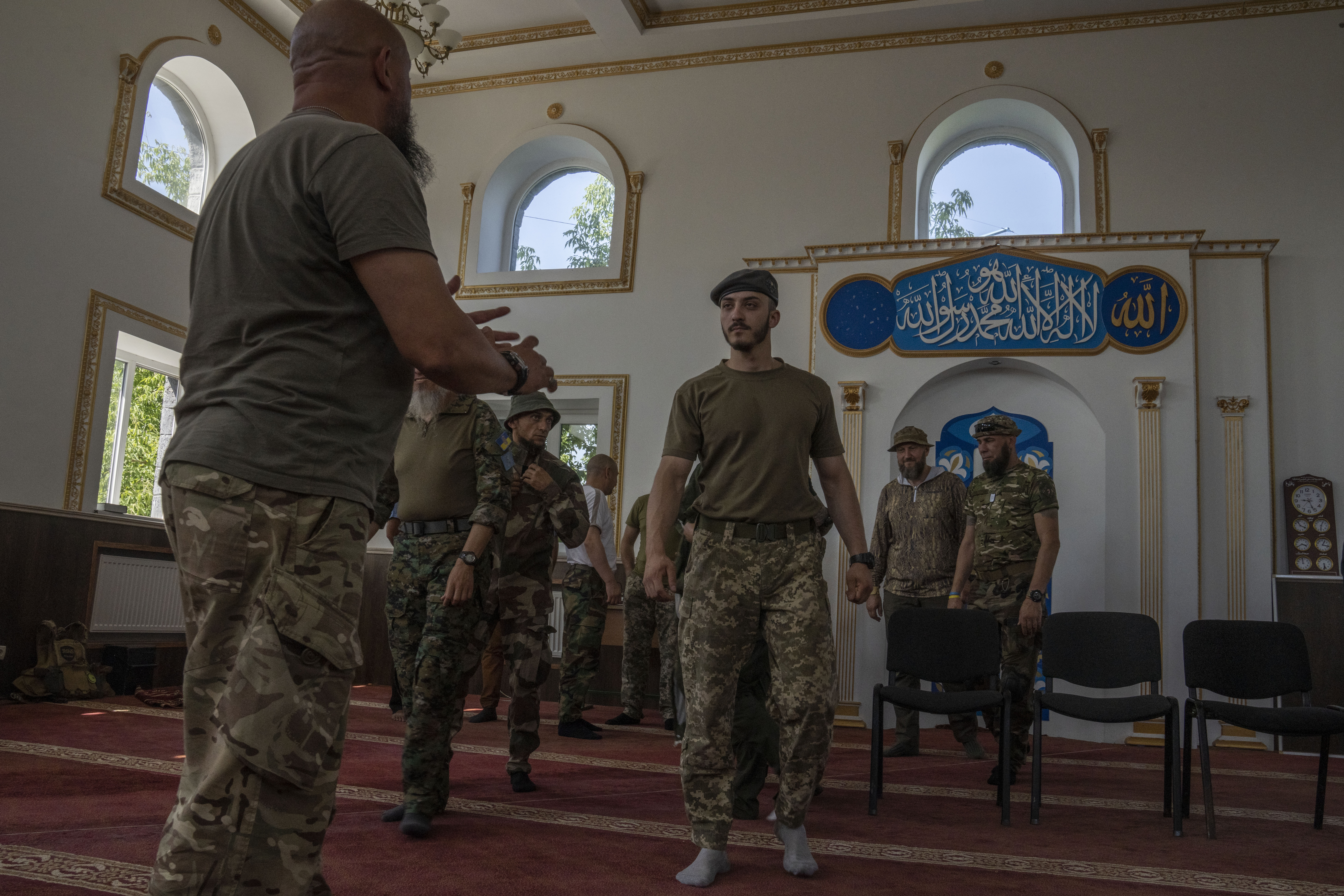 Ukrainian Muslim soldiers talk after prayers on the first day of Eid al-Adha in Medina Mosque, Kostiantynivka