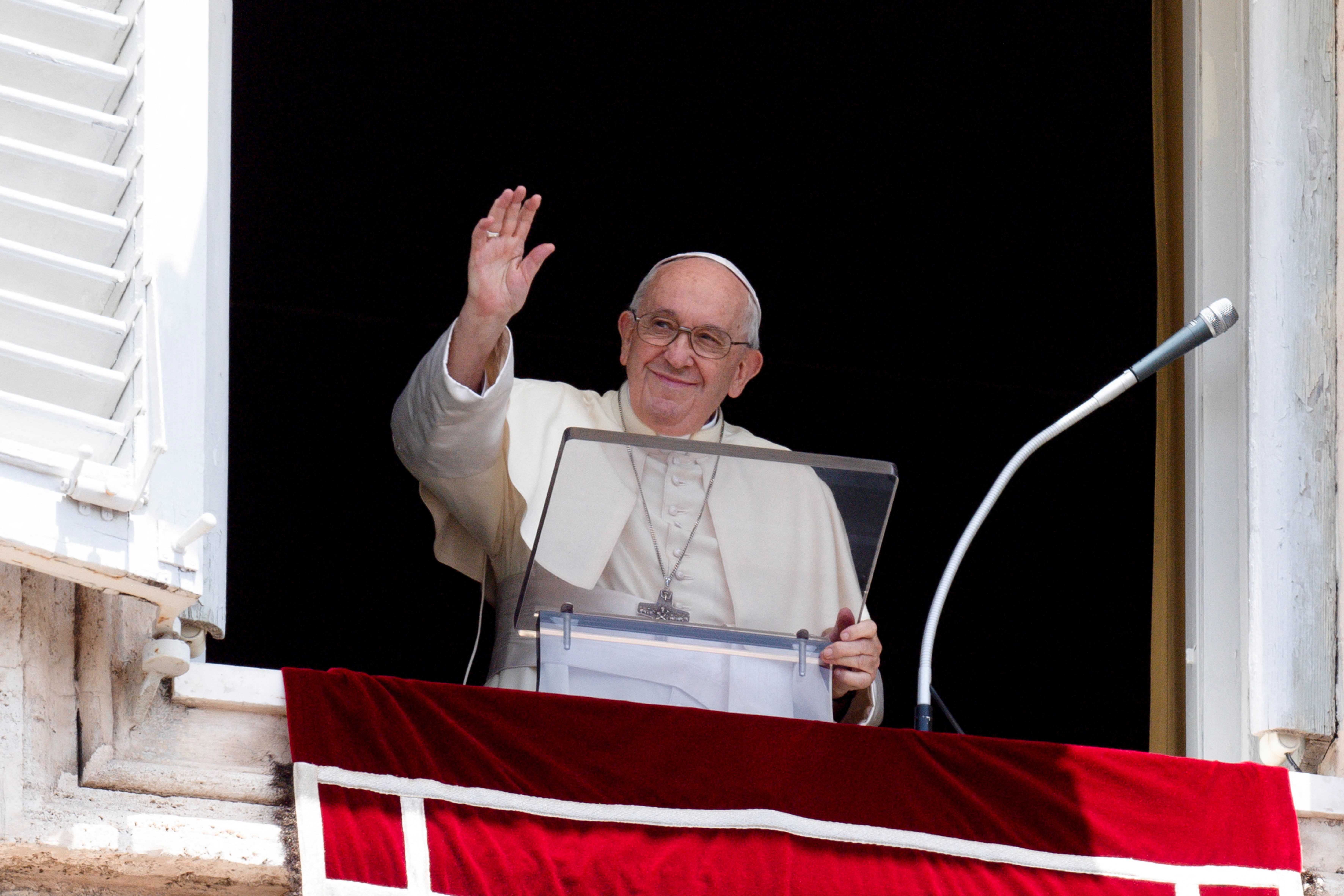 Pope Francis waves as he leads the Angelus prayer from his window, at the Vatican July 3, 2022