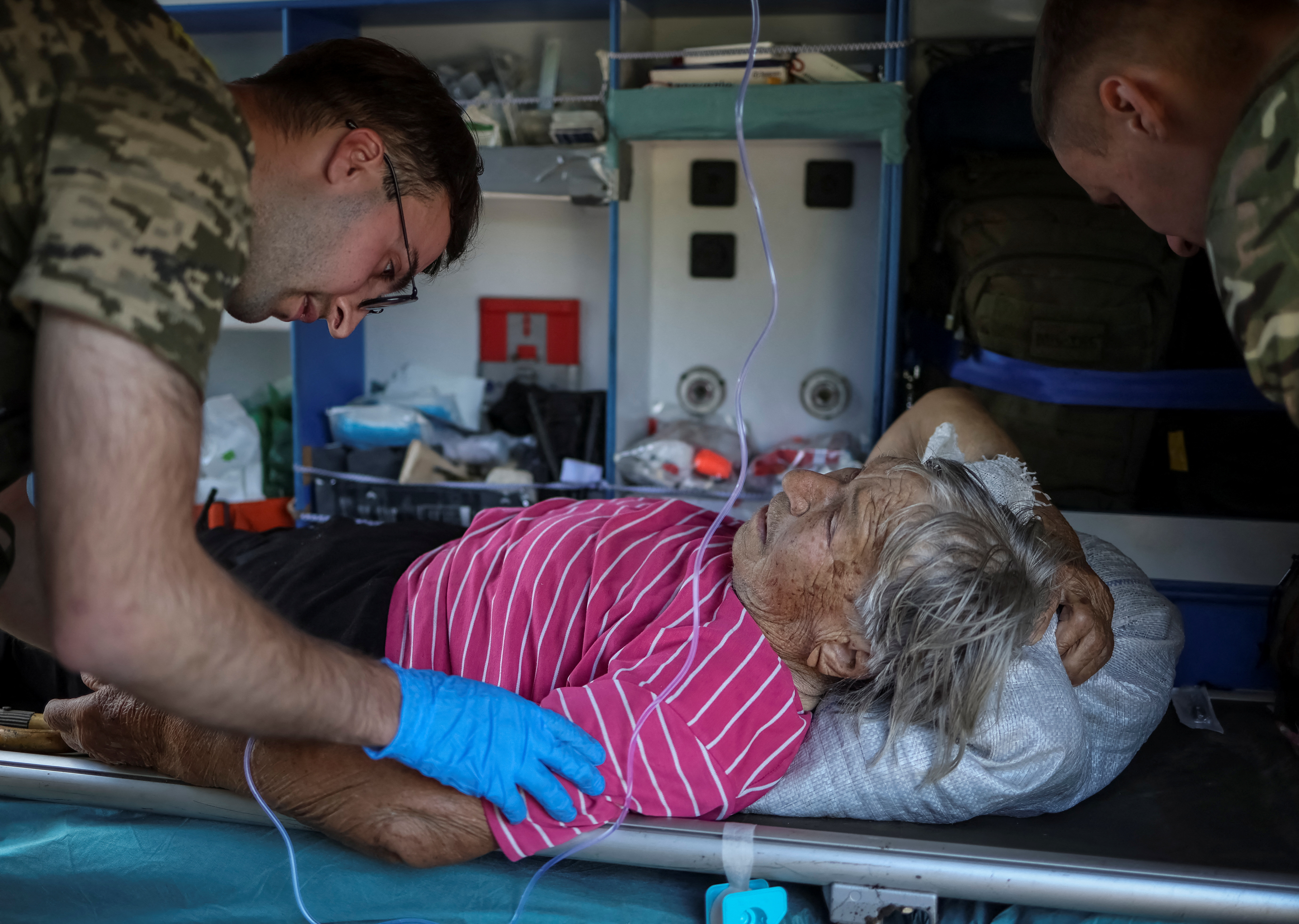 Ukrainian military paramedics attend resident Nina Trofimenko, 86, who was wounded during shelling near the front line in the Donbas region, Ukraine July 12, 2022