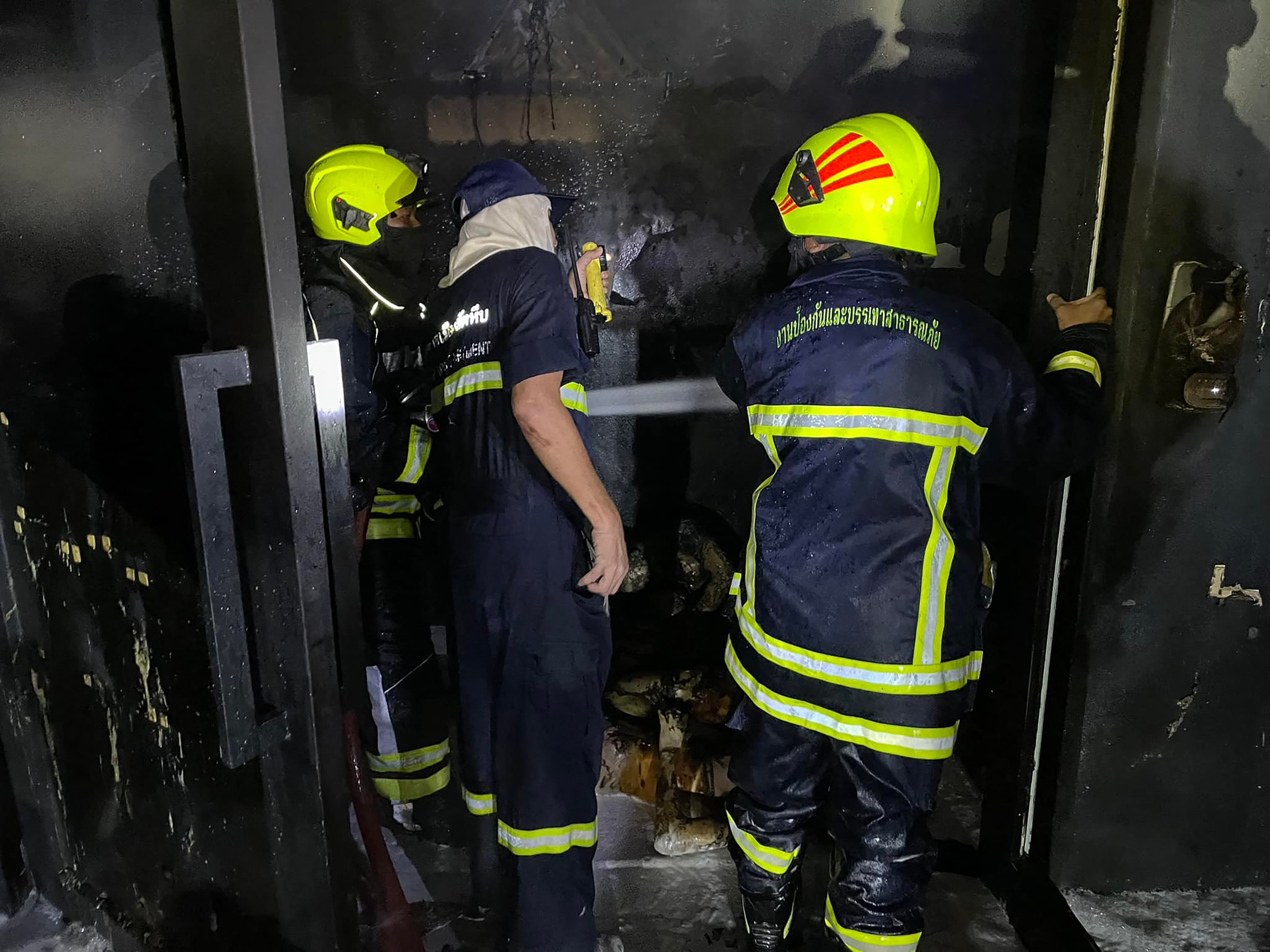 Rescue workers inside the Mountain B nightclub after a fire in Sattahip district in Thailand's Chonburi province