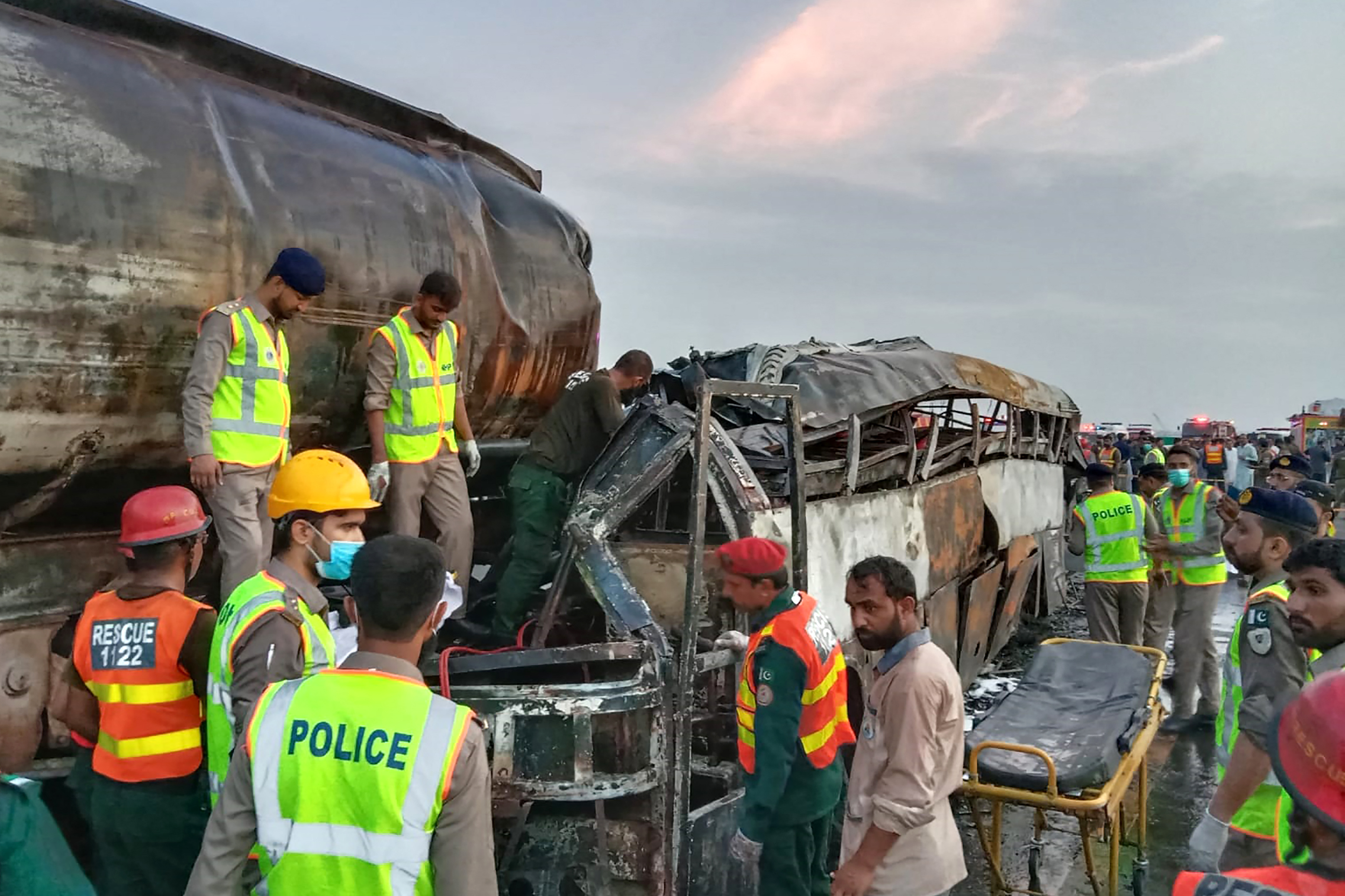 Rescue workers search for victims in the wreckage of the bus [AFP]