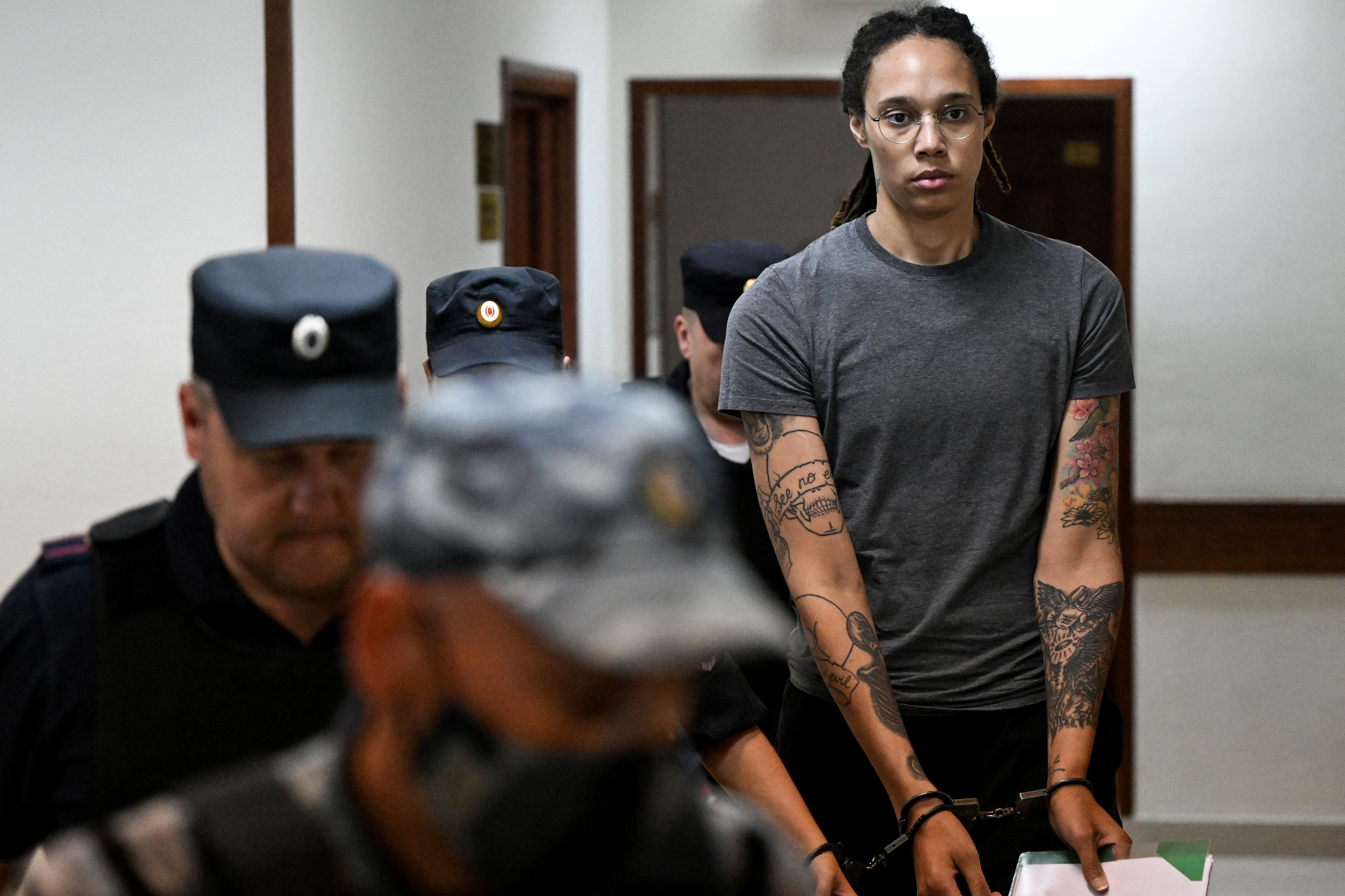 US basketball player Brittney Griner, who was detained at Moscow’s Sheremetyevo airport and later charged with illegal possession of cannabis, is escorted in a court building in Khimki outside Moscow, Russia