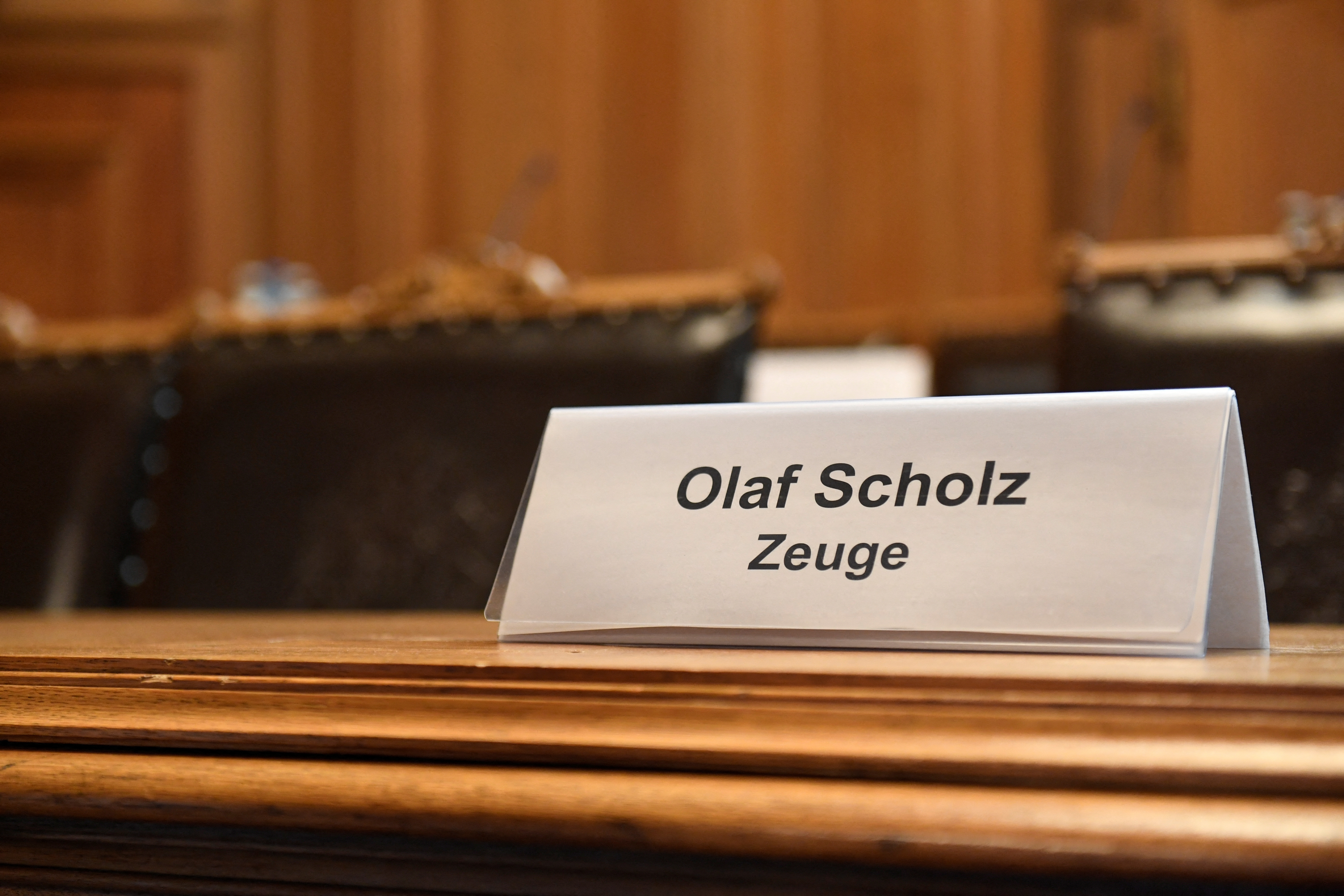 A sign reading, "Olaf Scholz Witness