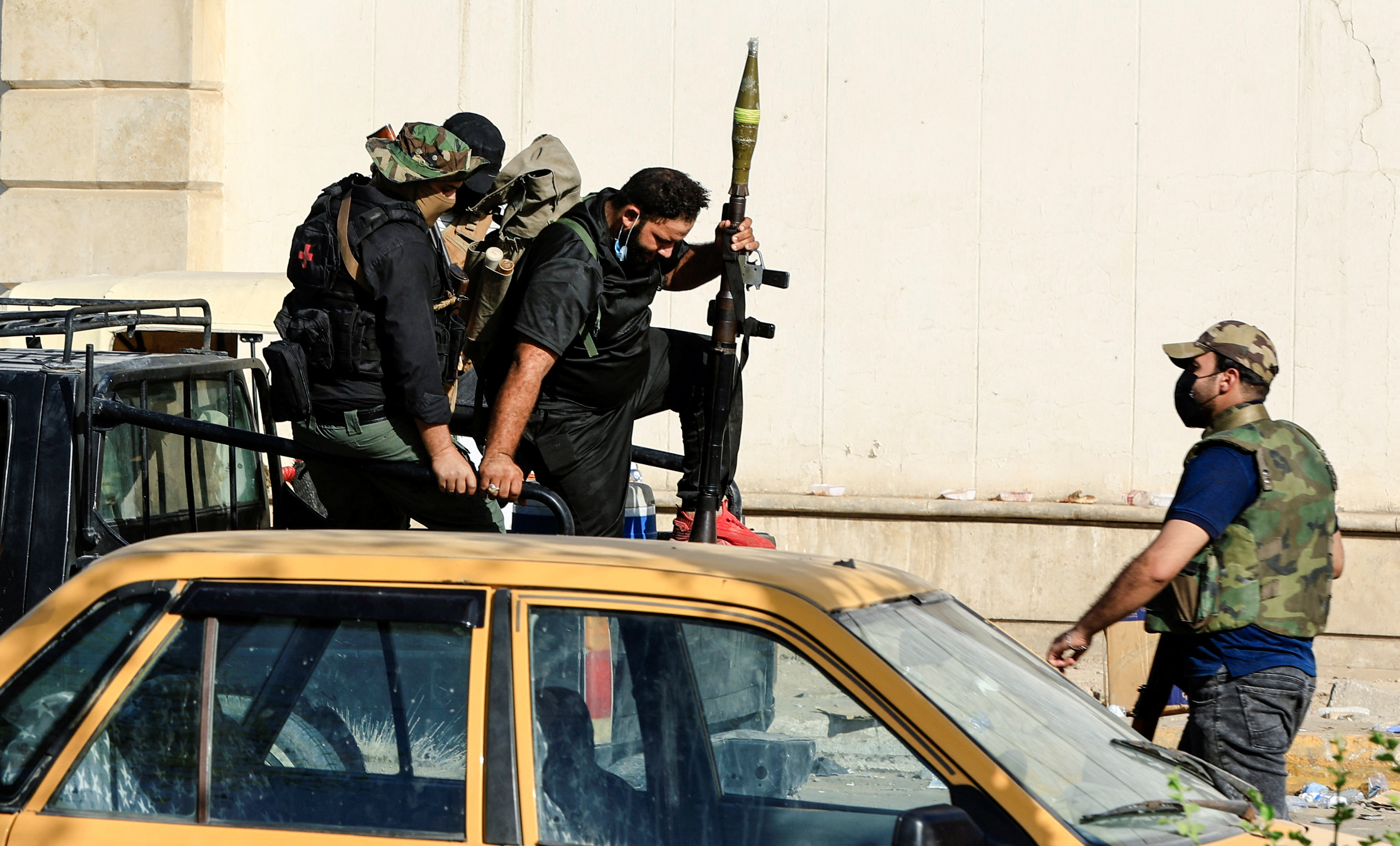 Members of Sadr's Peace Brigades fighters gather during clashes with the Iraqi security forces near the Green Zone, in Baghdad, Iraq