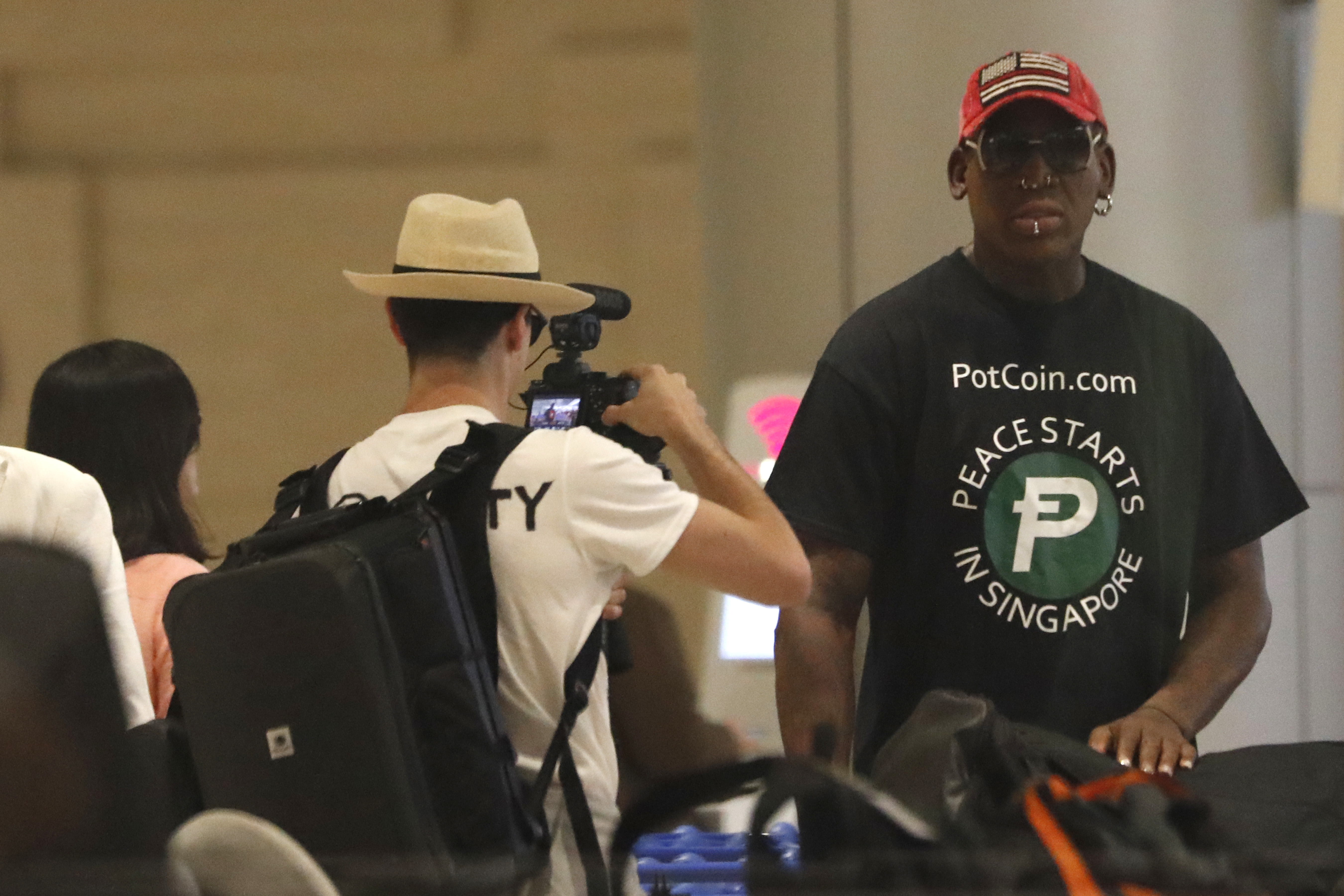 Former NBA basketball player Dennis Rodman arrives at Singapore’s Changi Airport on June 12, 2018