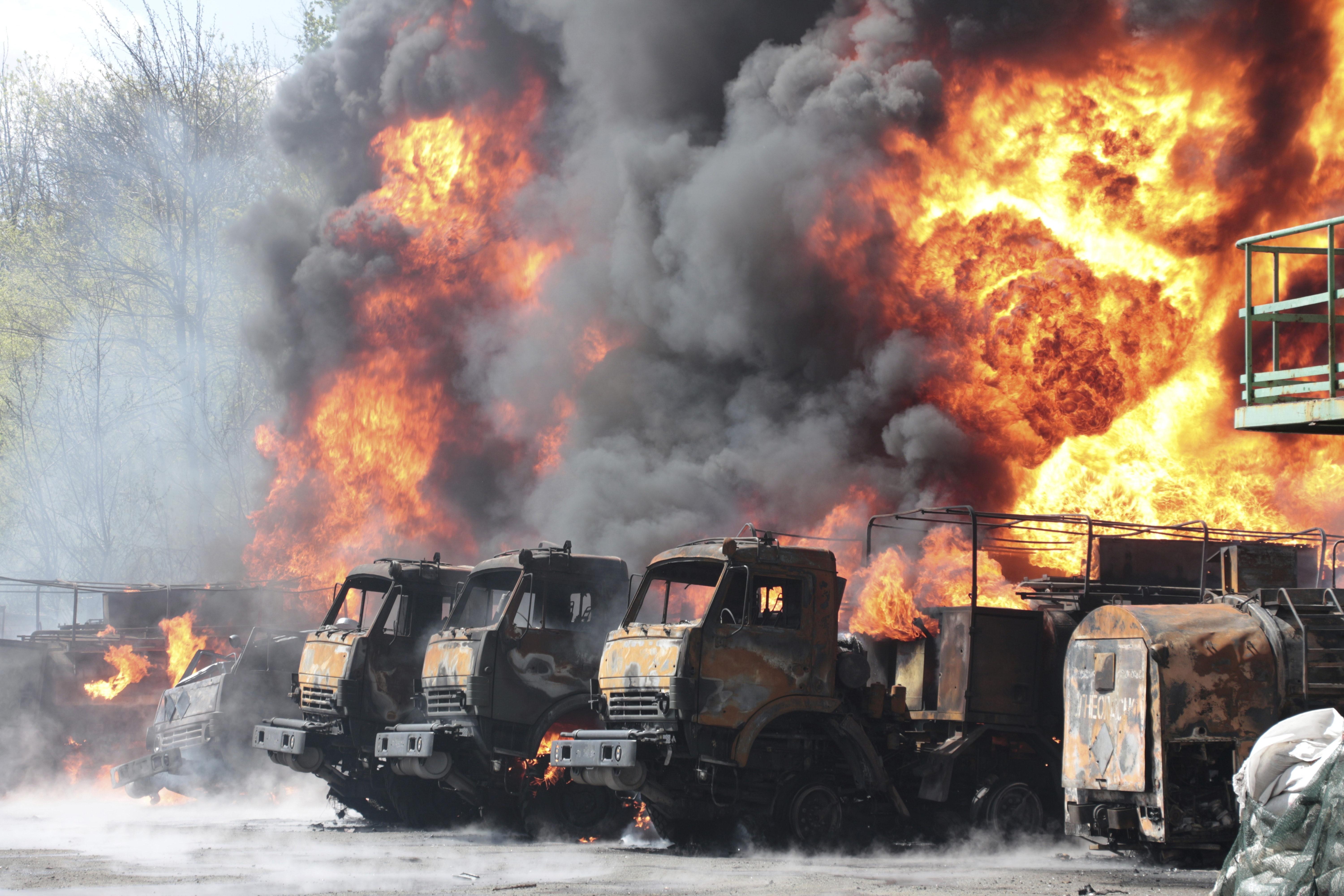 Vehicles are on fire at an oil depot after missiles struck the facility in an area controlled by Russian-backed separatist forces in Makiivka, 15 km (94 miles) east of Donetsk