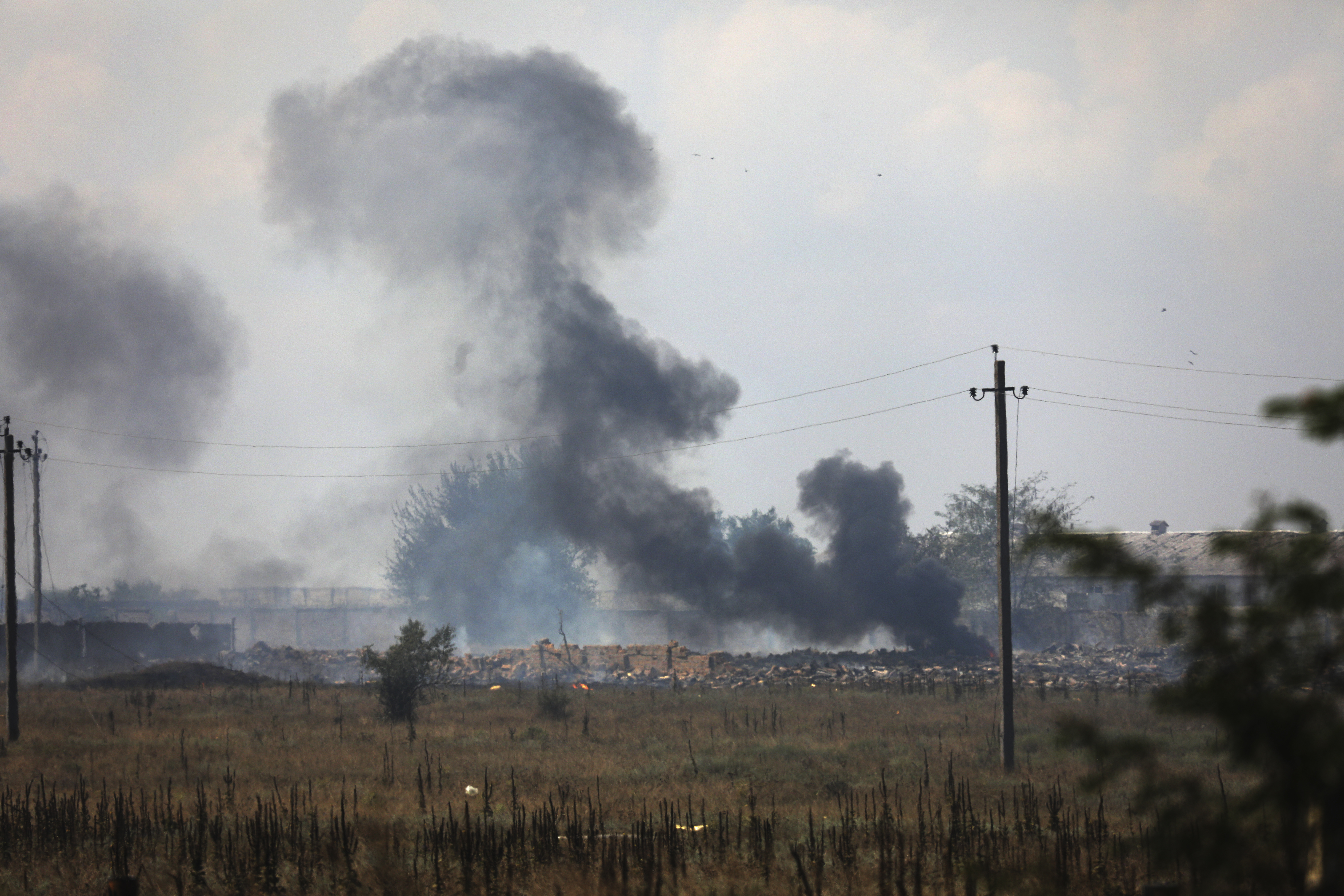 Smoke rises over the site of an explosion at a suspected ammunition storage site of the Russian army near the village of Mayskoye, Crimea, on August 16