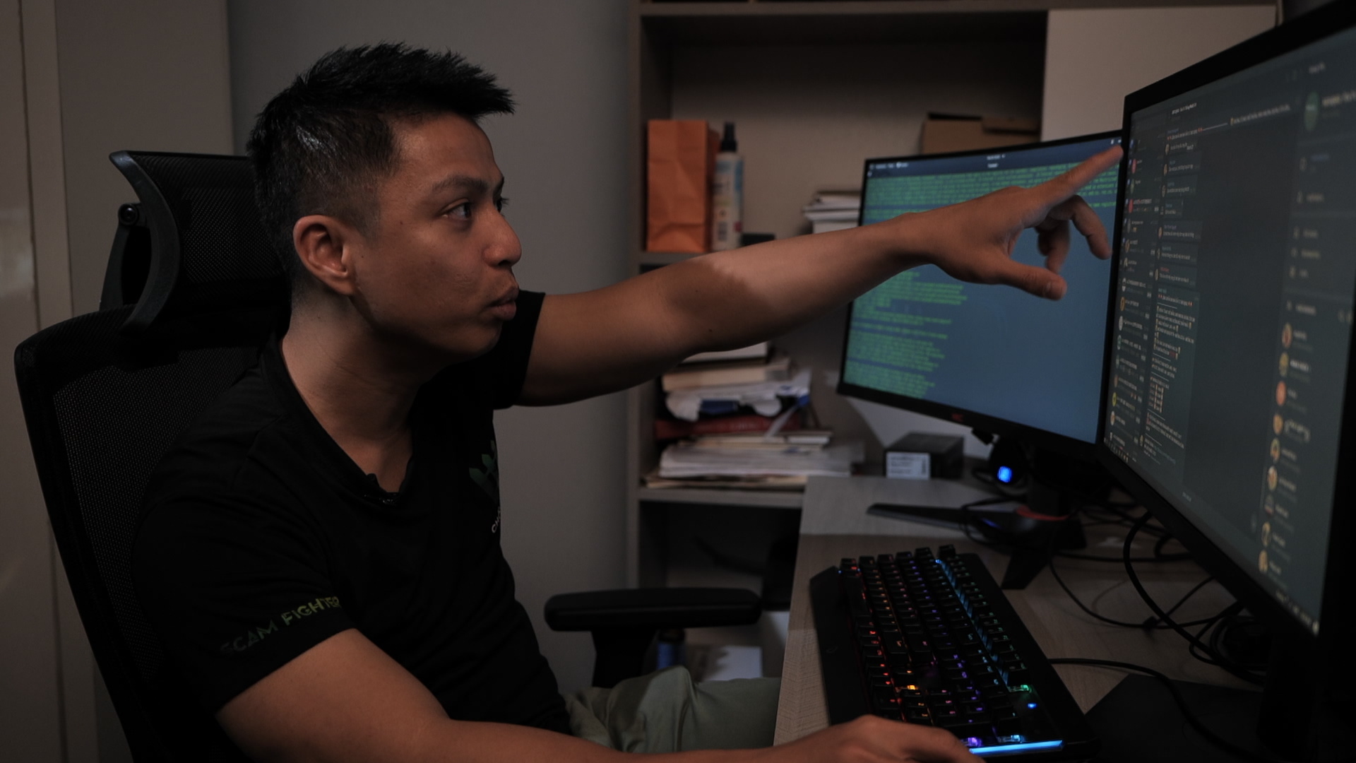 A man works on a computer, tracking cyber scam operations