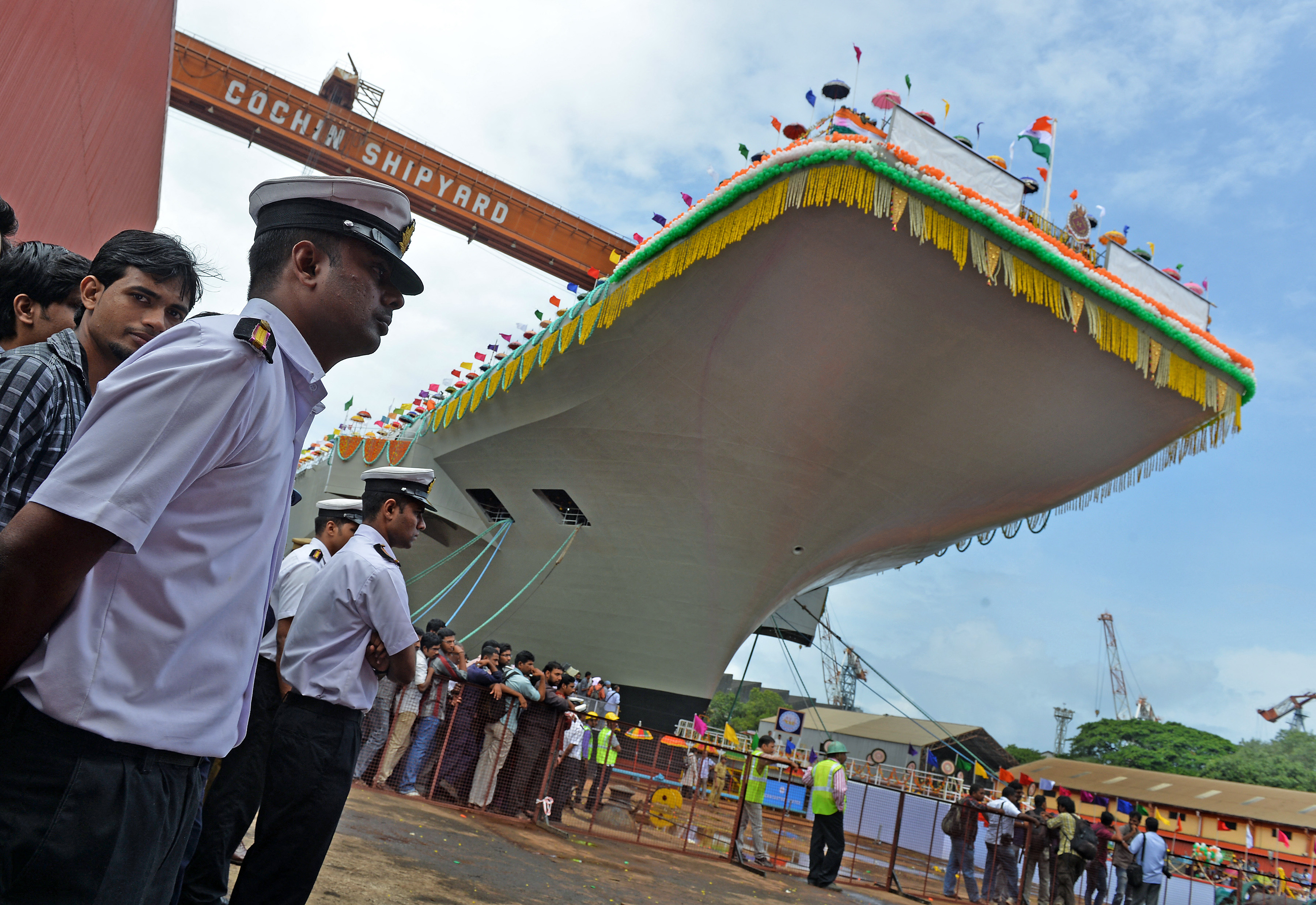 Indian naval officers stand guard during the launch of the indigenously-built aircraft carrier, the INS Vikrant