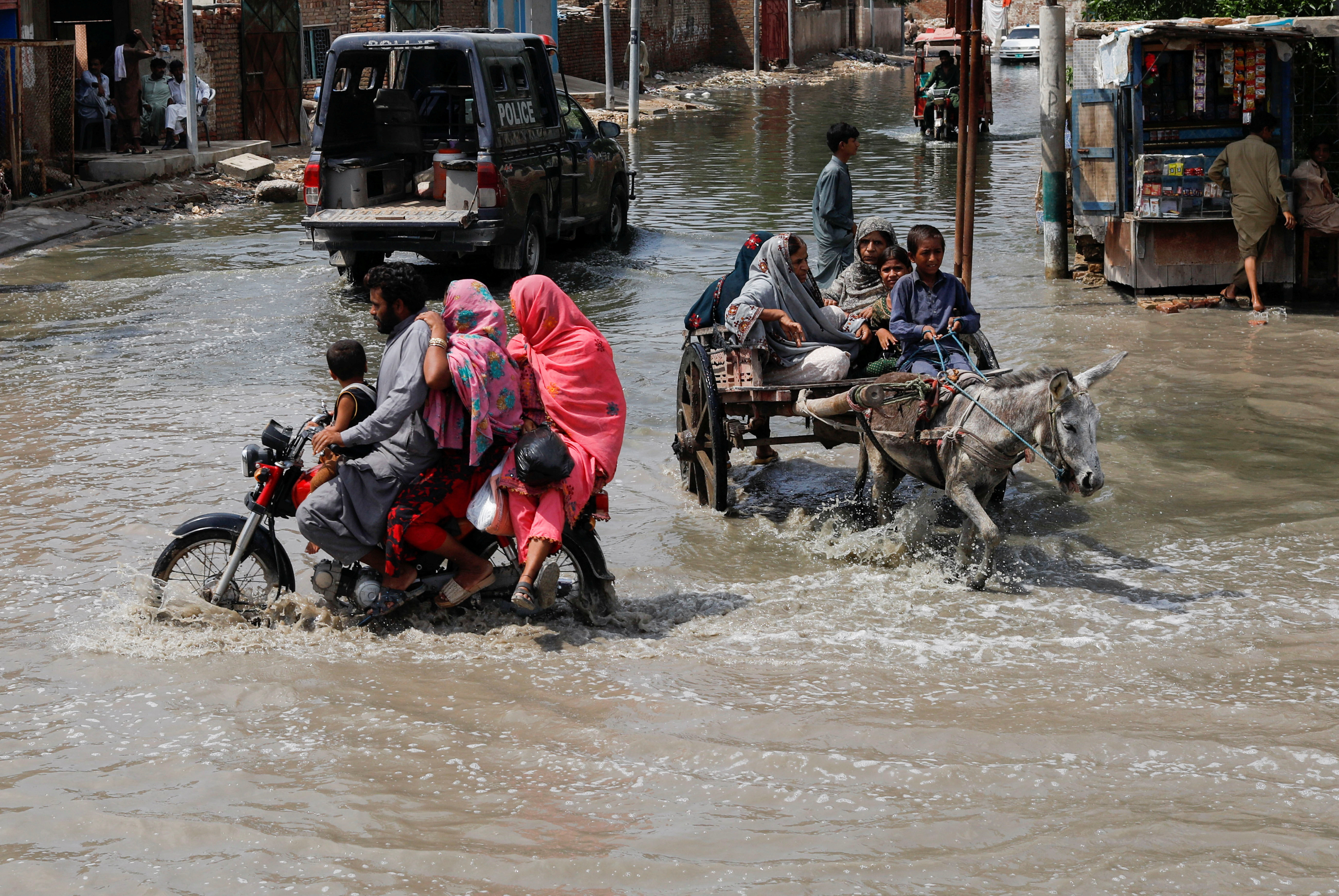 Commuters travel through rain waters, following rains and floods.
