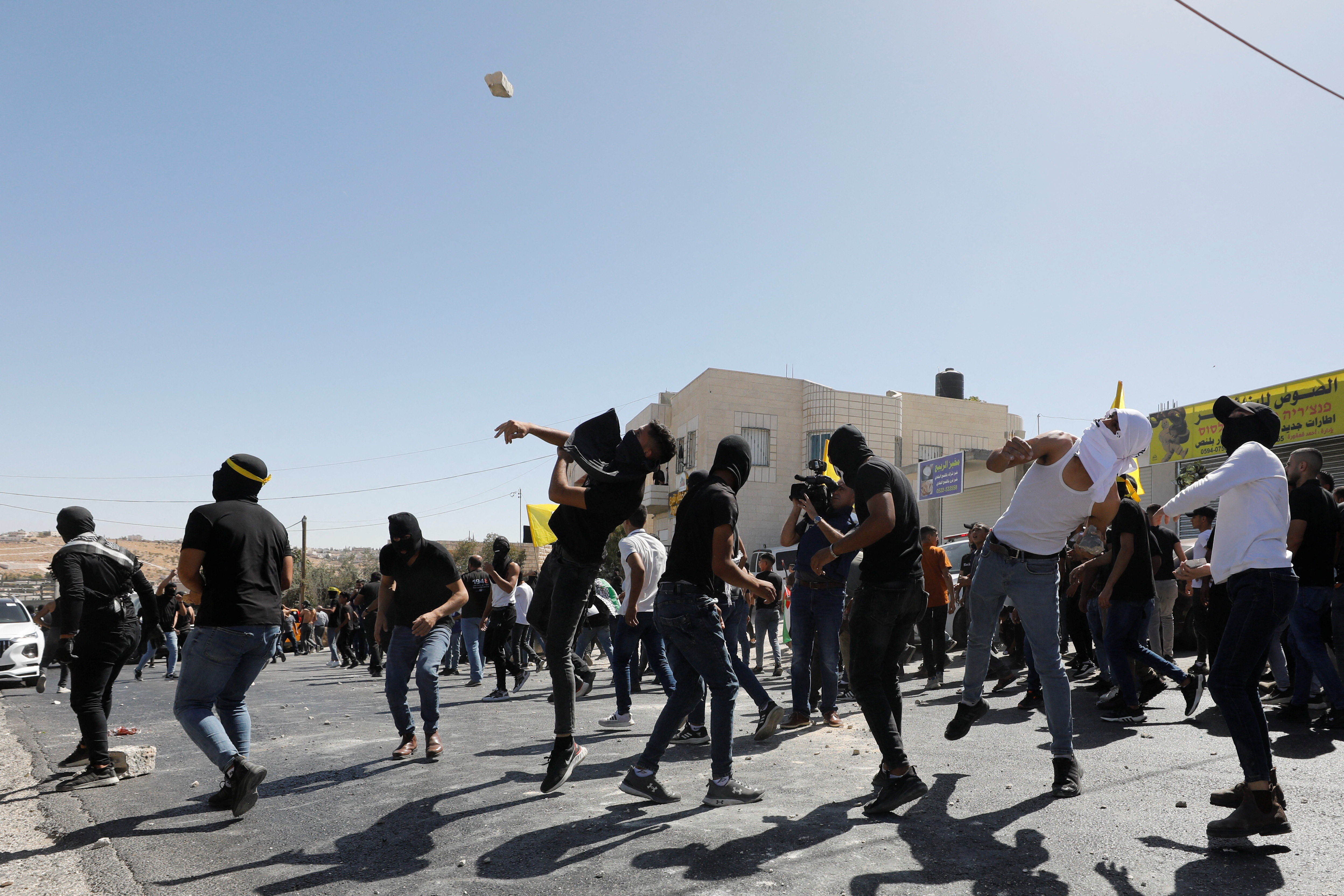 Protesters throw stones during confrontations following Rayan’s funeral