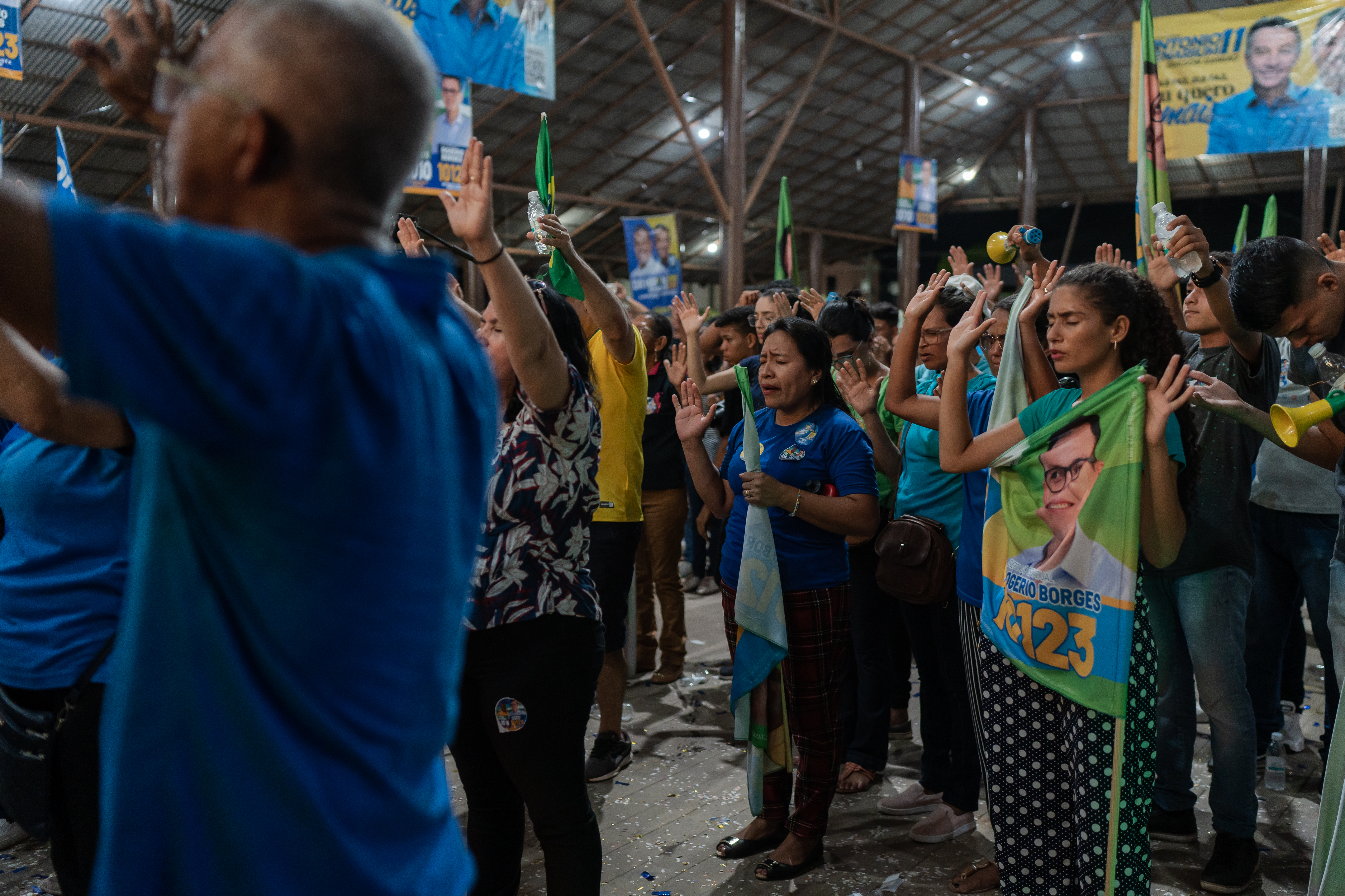 People praying at a political campaign event