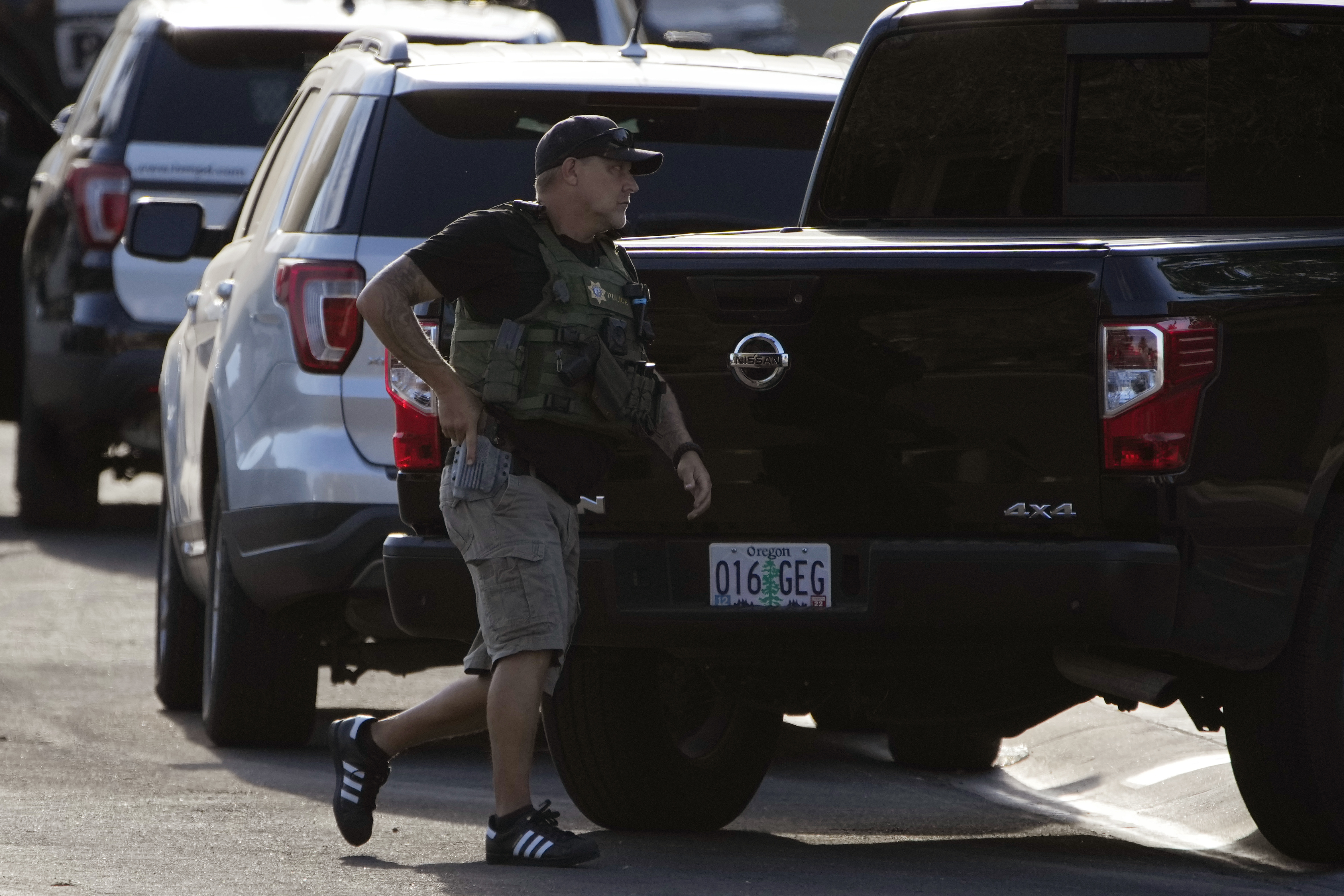 A police officer takes up a position around the house of Clark County Public Administrator Robert Telles