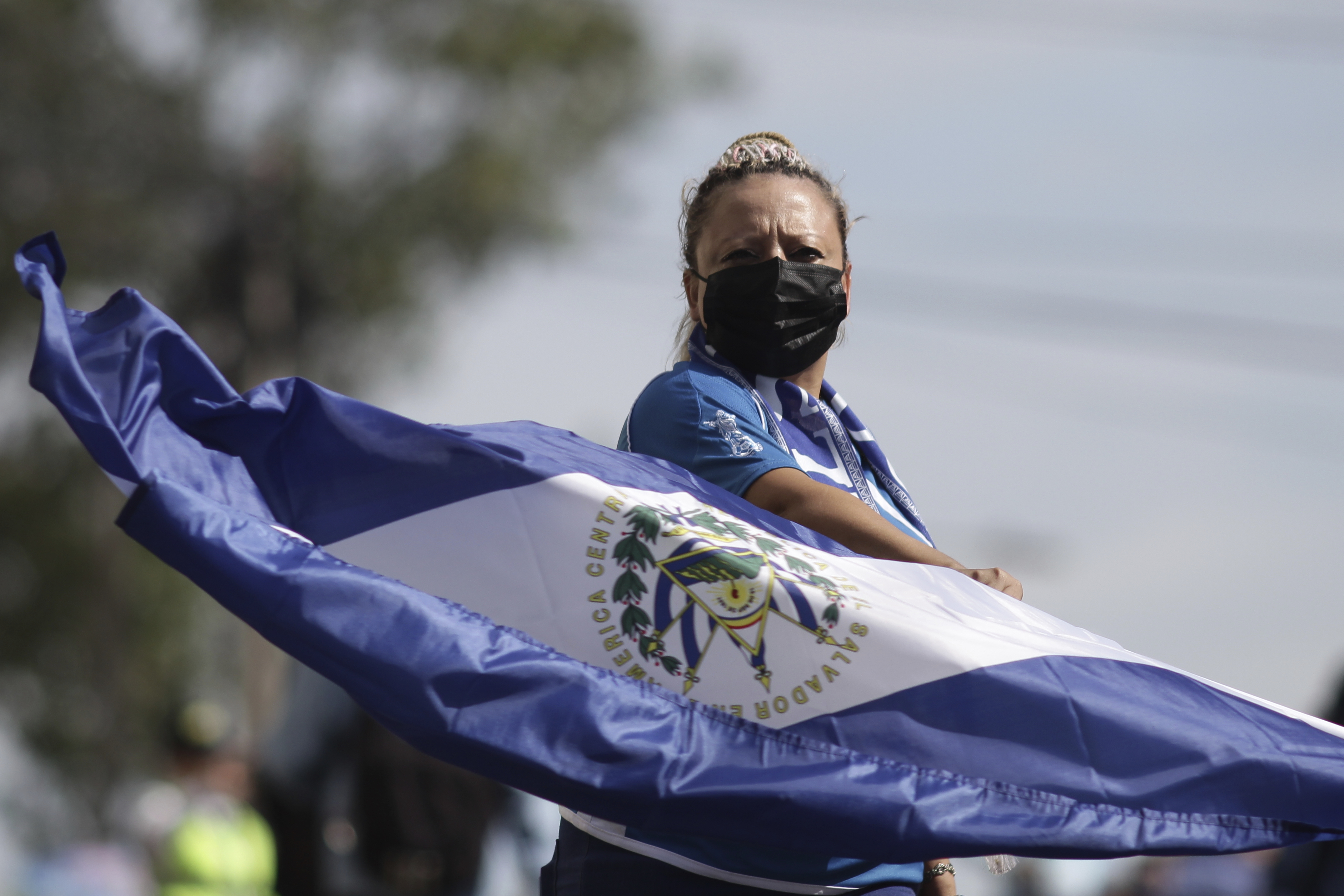 A person waves a flag during an anti-government march on Independence Day in San Salvador, El Salvador