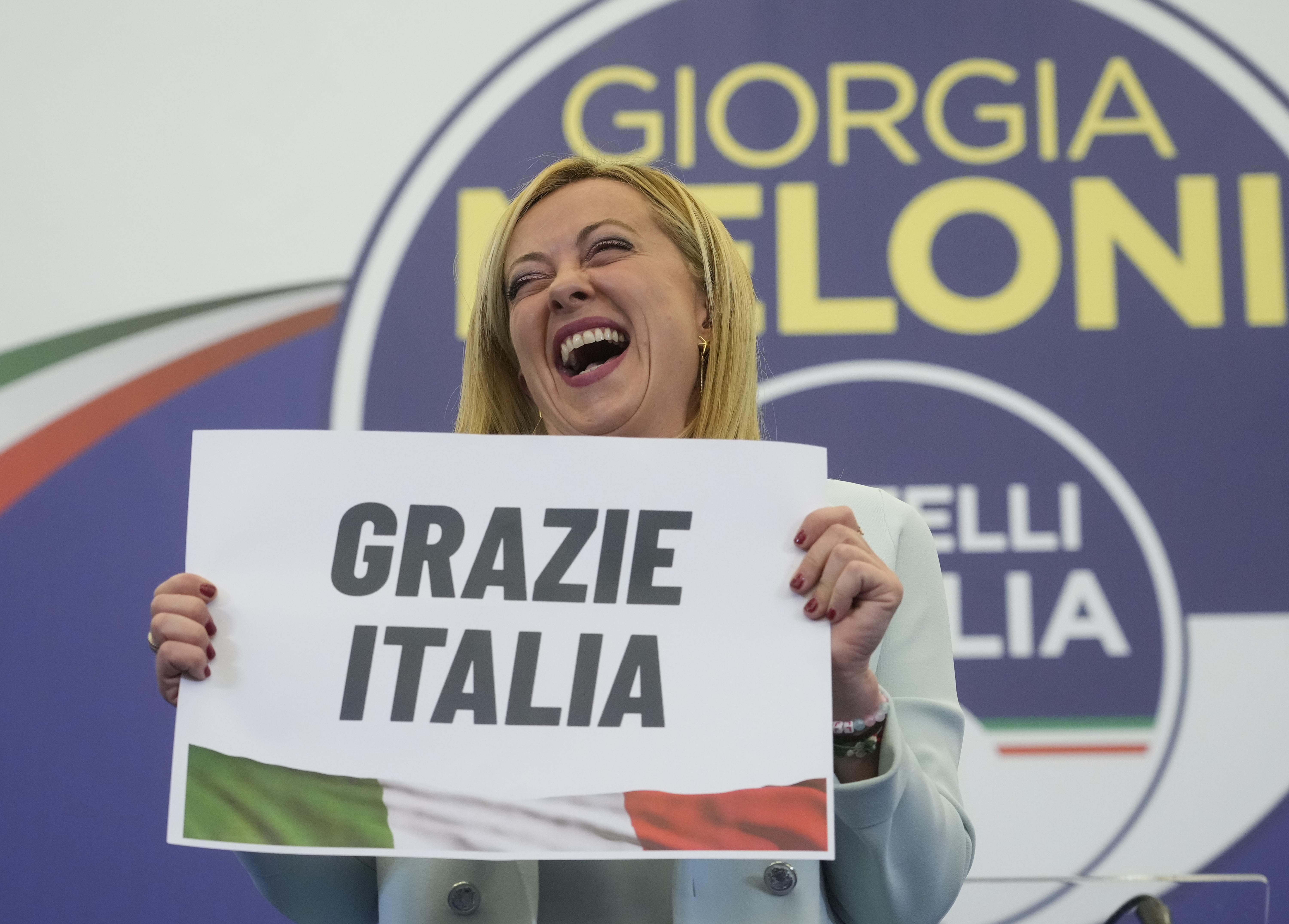 Far-Right party Brothers of Italy's leader Giorgia Meloni shows a placard reading in Italian "Thank you Italy" at her party's electoral headquarters in Rome, early Monday, Sept. 26, 2022. Italians voted in a national election that might yield the nation's first government led by the far right since the end of World War II. (AP Photo/Gregorio Borgia)
