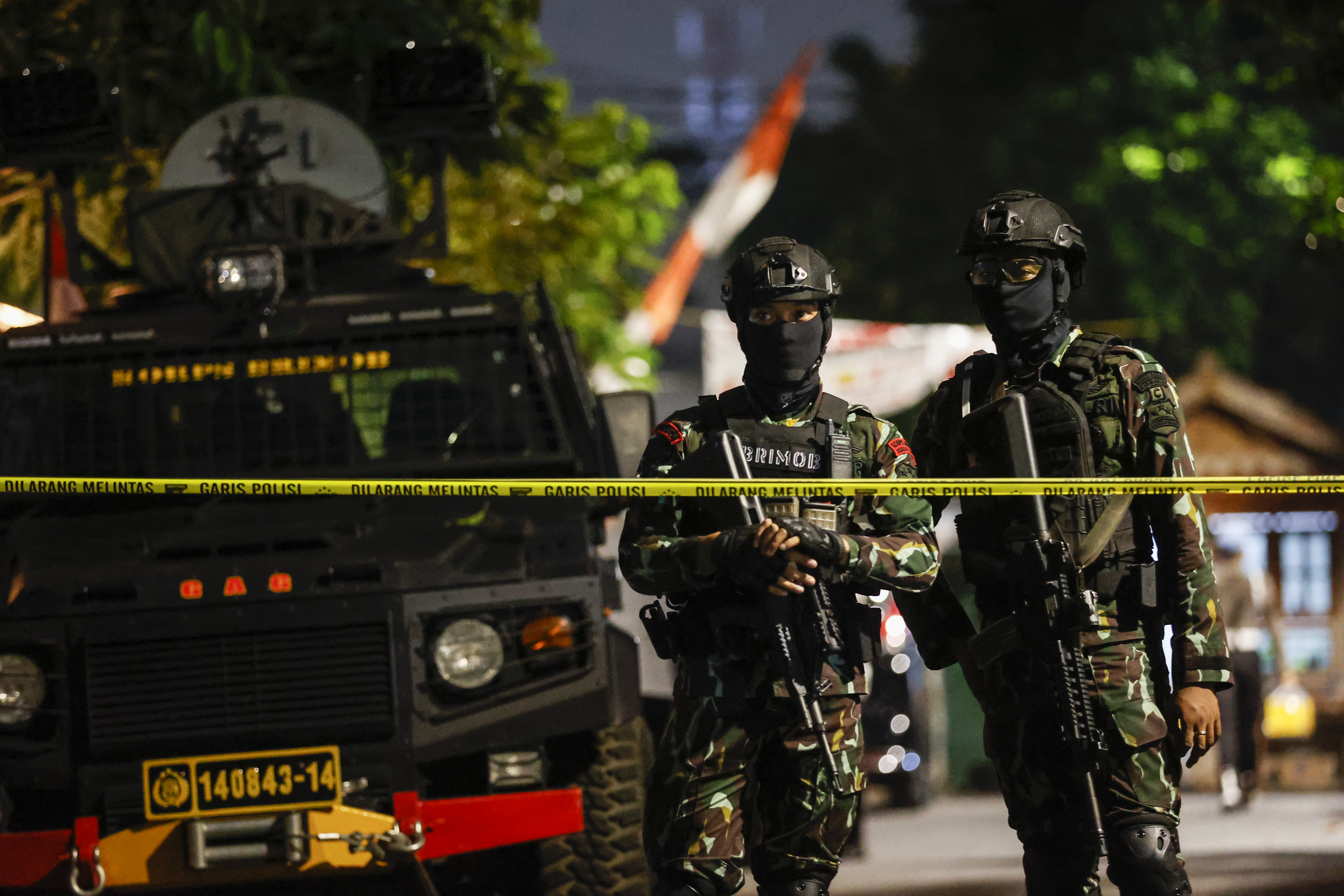 Armed Brimob officers in fatigues on guard outside as officers search the home of Ferdy Sambo 