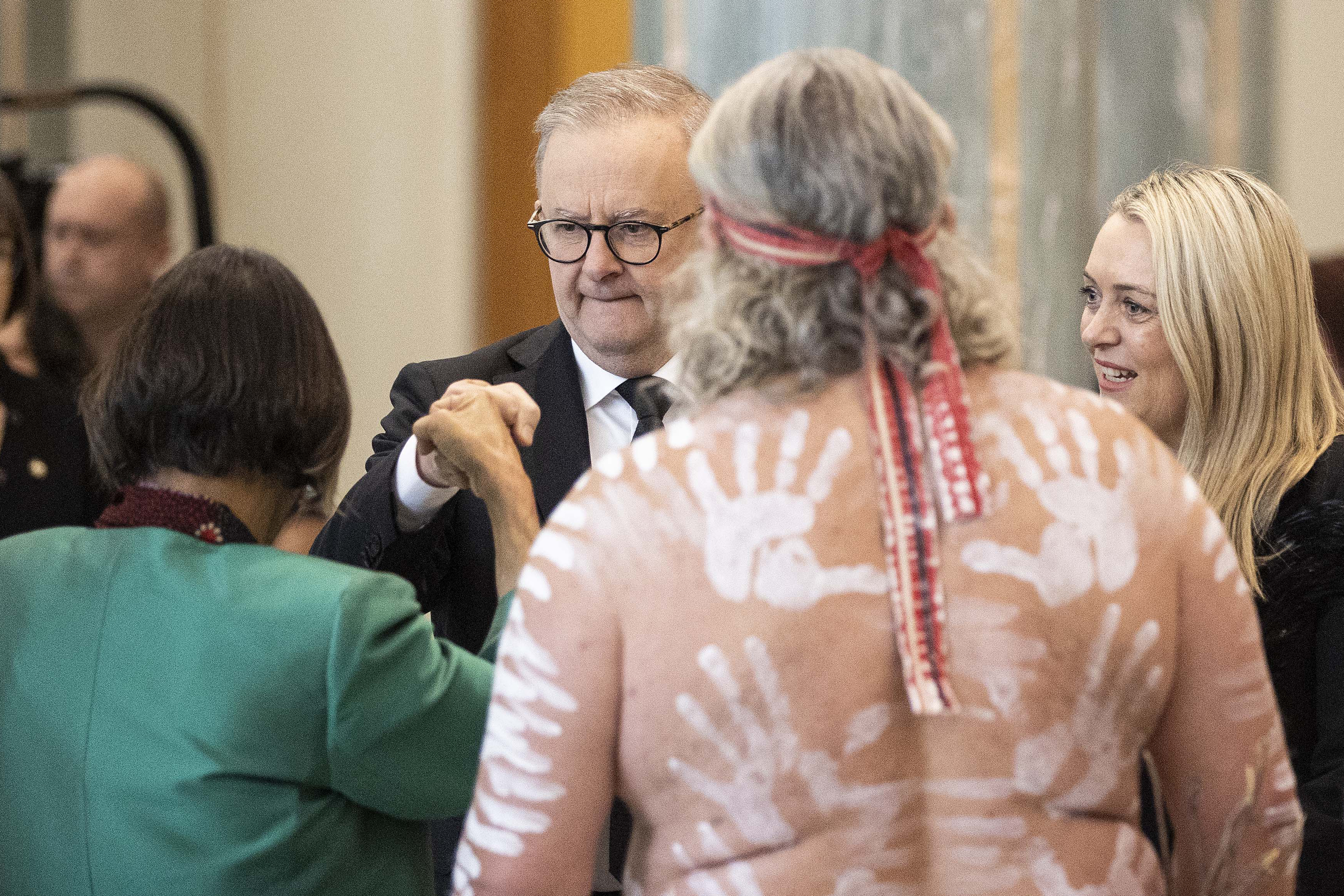 Australia's Prime Minister Anthony Albanese (C) greets Indigenous elders at a national memorial for Queen Elizabeth II