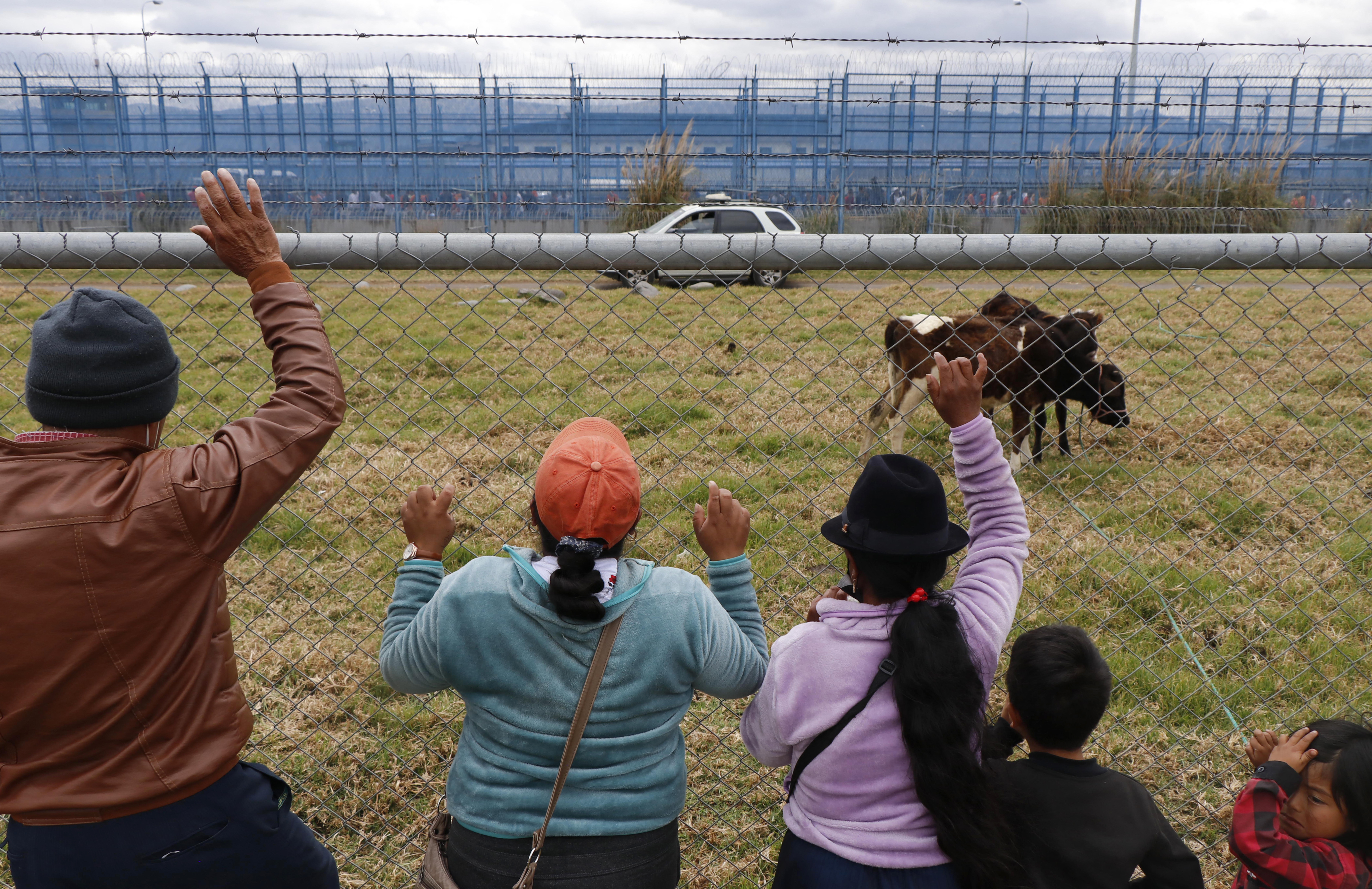 Relatives stand outside the prison in Latacunga, Ecuador, where deadly clashes erupted this week, on October 4, 2022