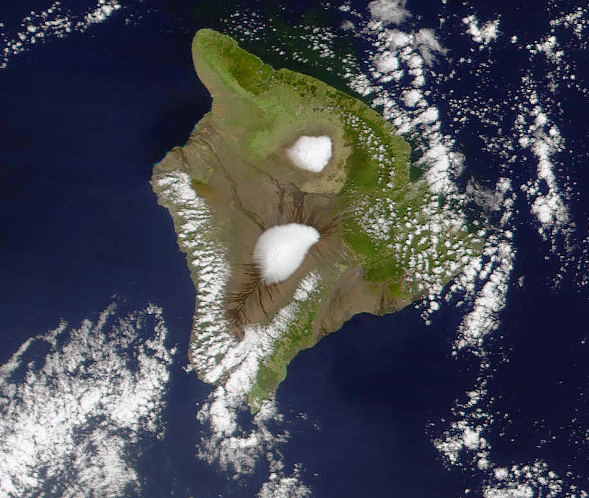 NASA satellite images show two peaks of snow on the tops of the Mauna Kea (upper) and Mauna Loa (lower) volcanoes with clouds above