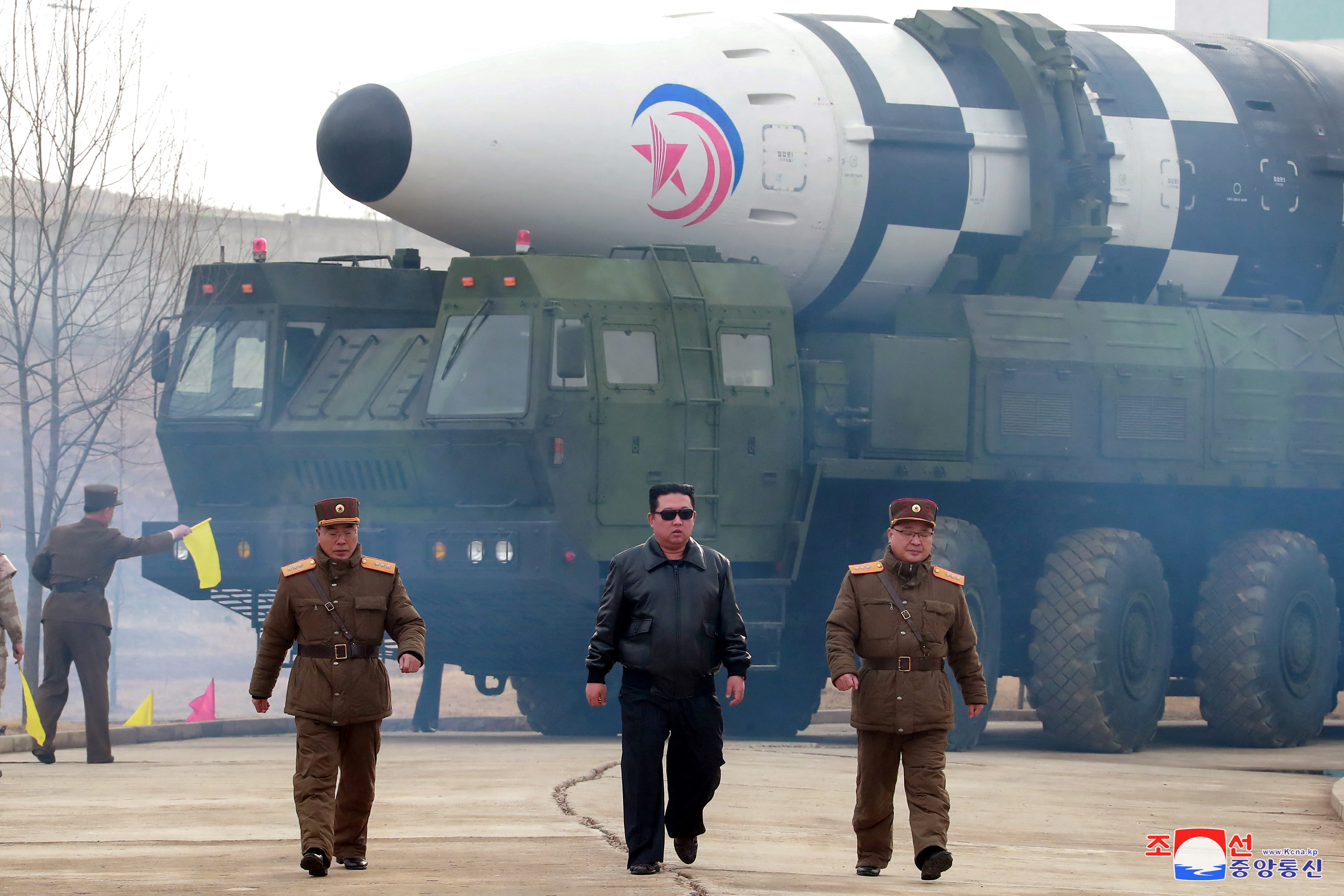 North Korean leader Kim Jong Un, centre, walks in front of an intercontinental ballistic missile in March, 2022