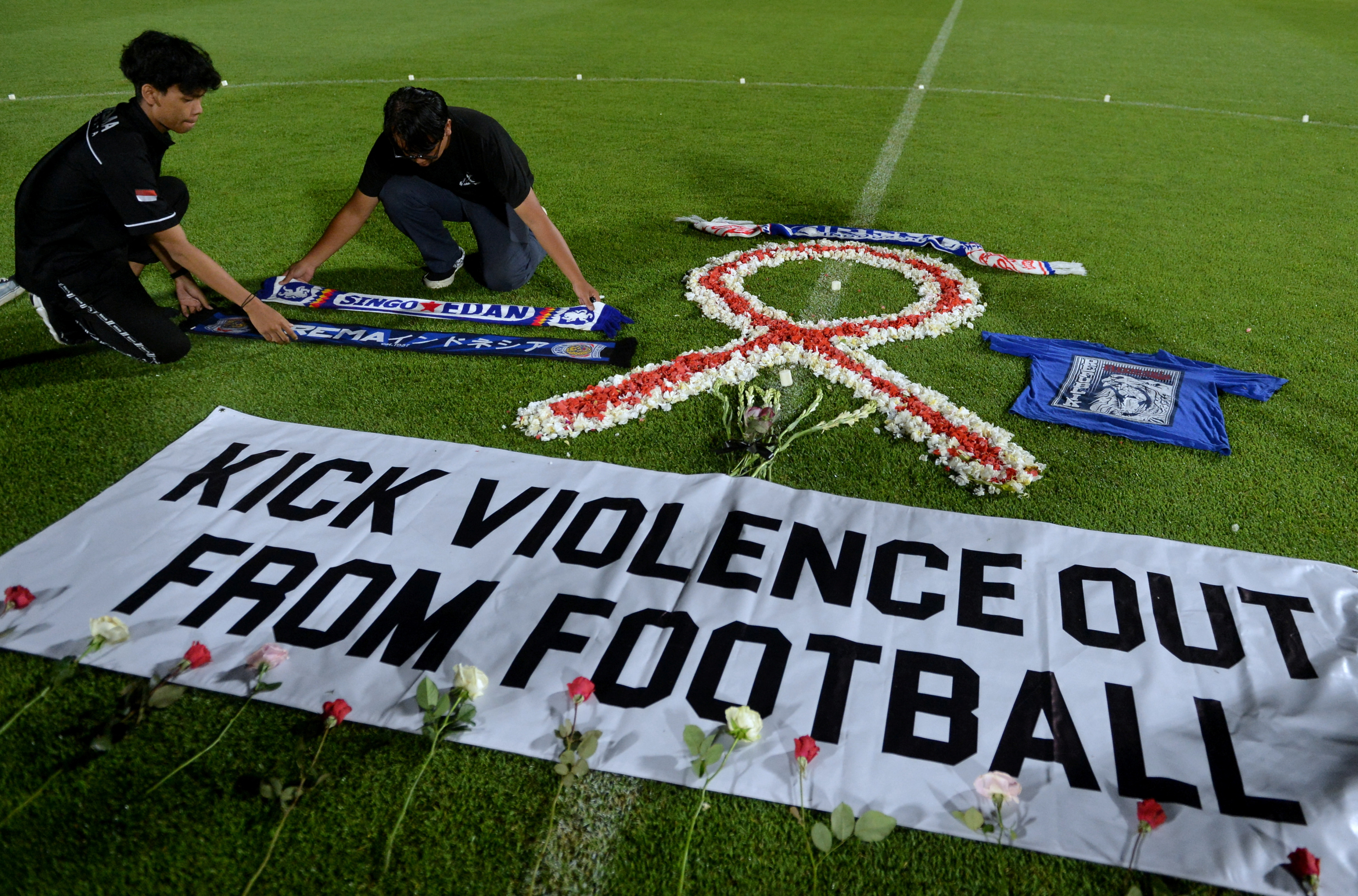 Football club supporters put Arema attribute during a vigil at Kapten I Wayan Dipta Stadium, after a riot and stampede at Kanjuruhan Stadium following a soccer match between Arema vs Persebaya?Surabaya, in Bali, Indonesia, October 3, 2022.