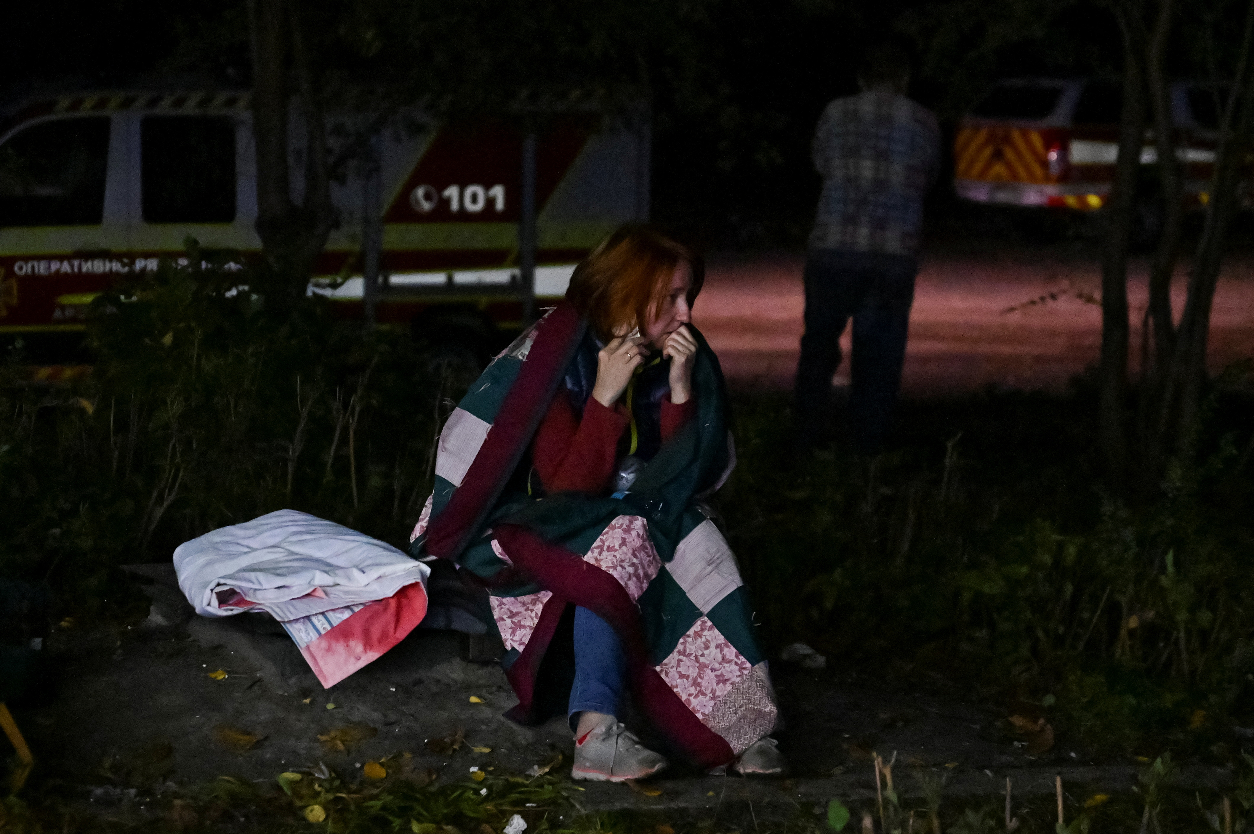 A local woman speaks on her mobile after being rescued from a residential building heavily damaged by a Russian missile attack, amid Russia’s attack on Ukraine, in Zaporizhzhia, Ukraine October 9, 2022 [Reuters]