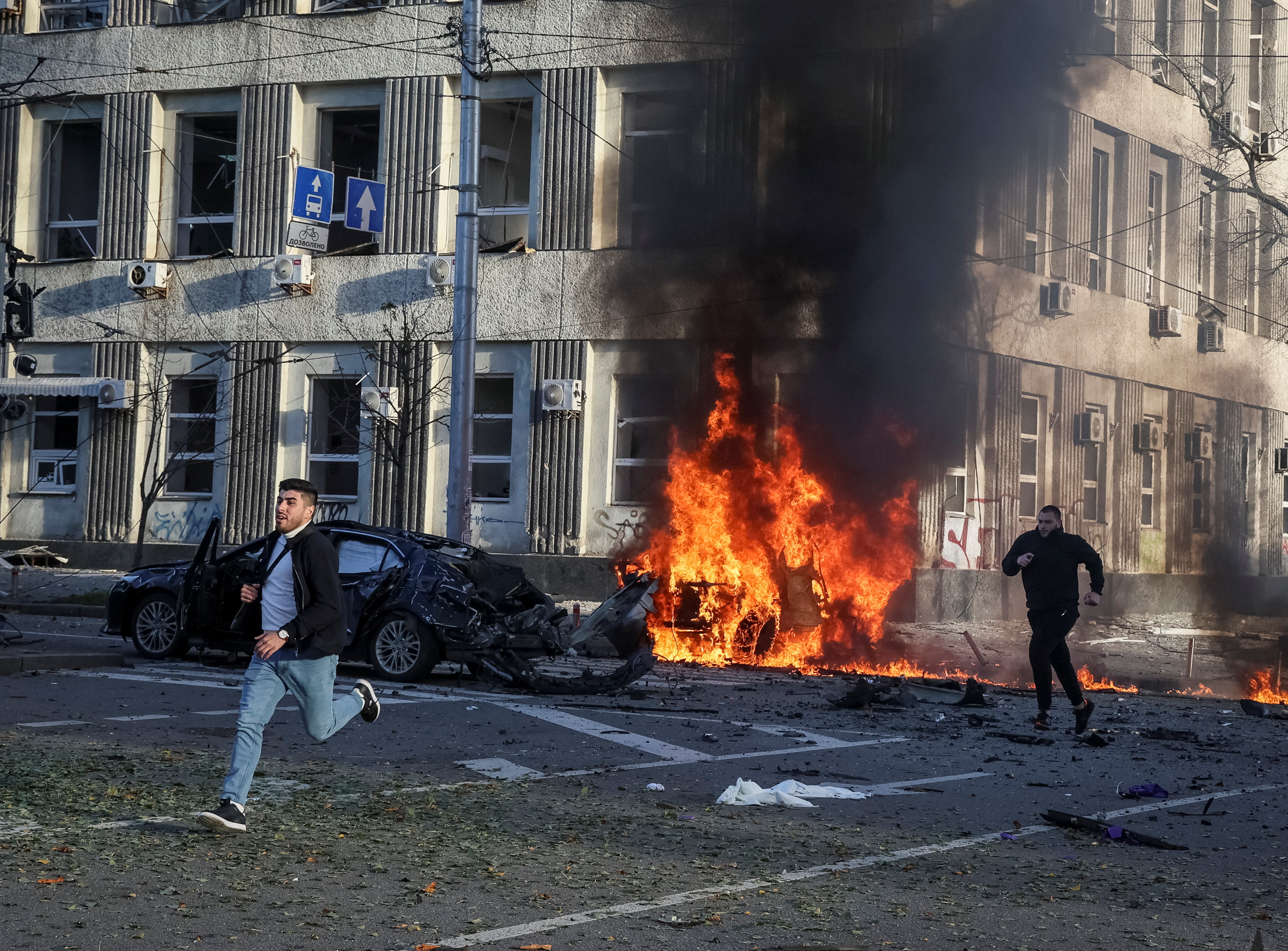 Cars burn after Russian military strike, as Russia's invasion of Ukraine continues, in central Kyiv.