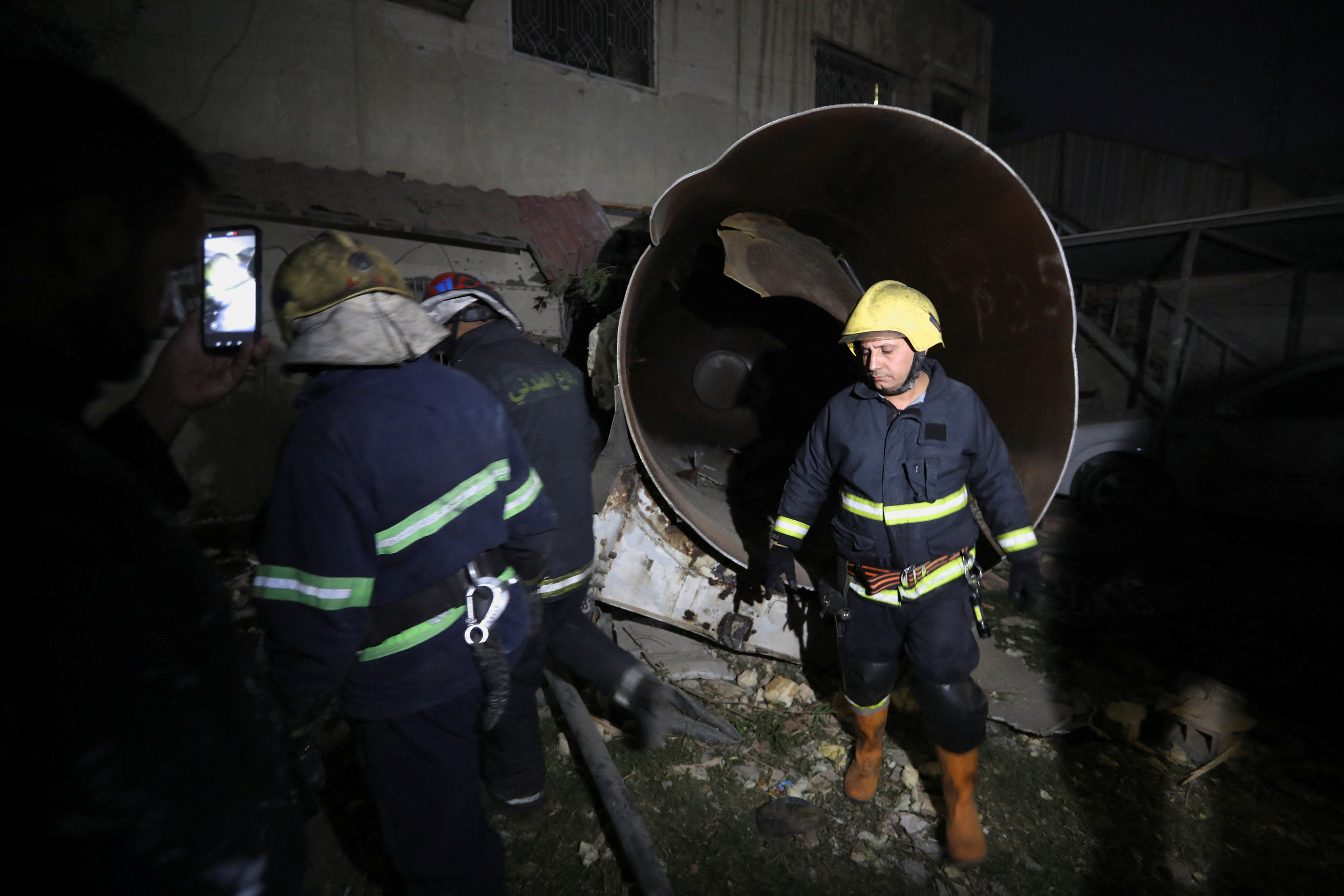 Firefighters inspect the site of an explosion in Baghdad, Iraq, October 29, 2022.