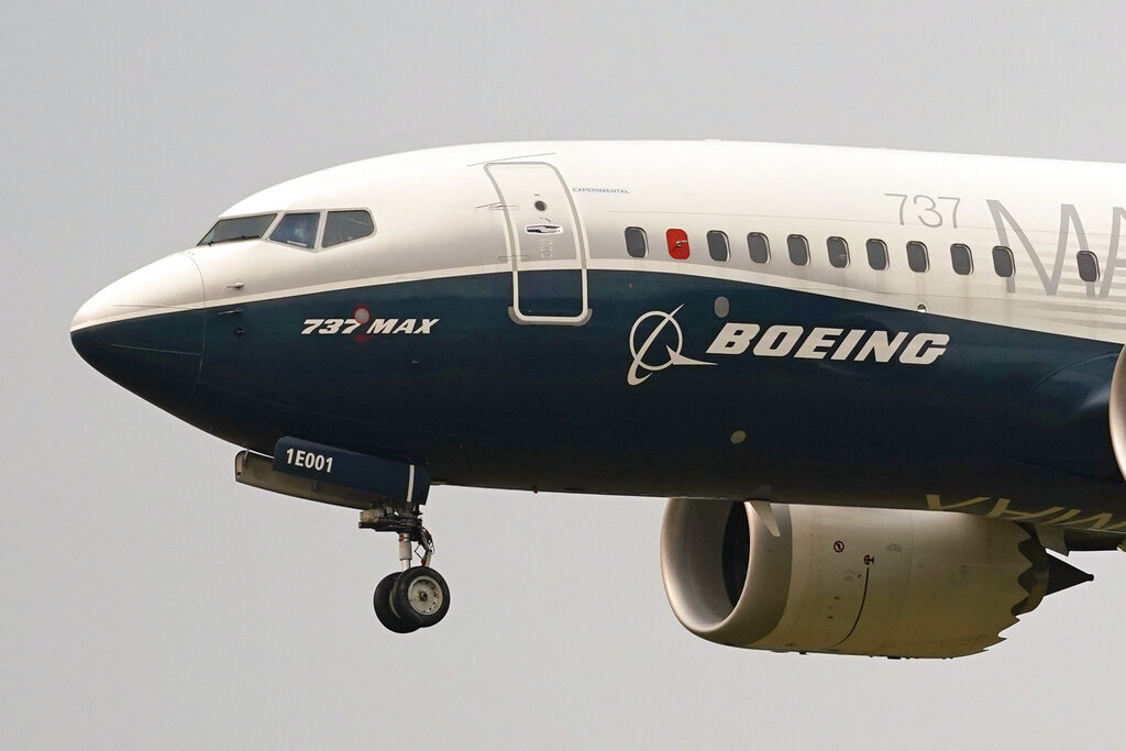 Front of Boeing jet in the air with front wheel out