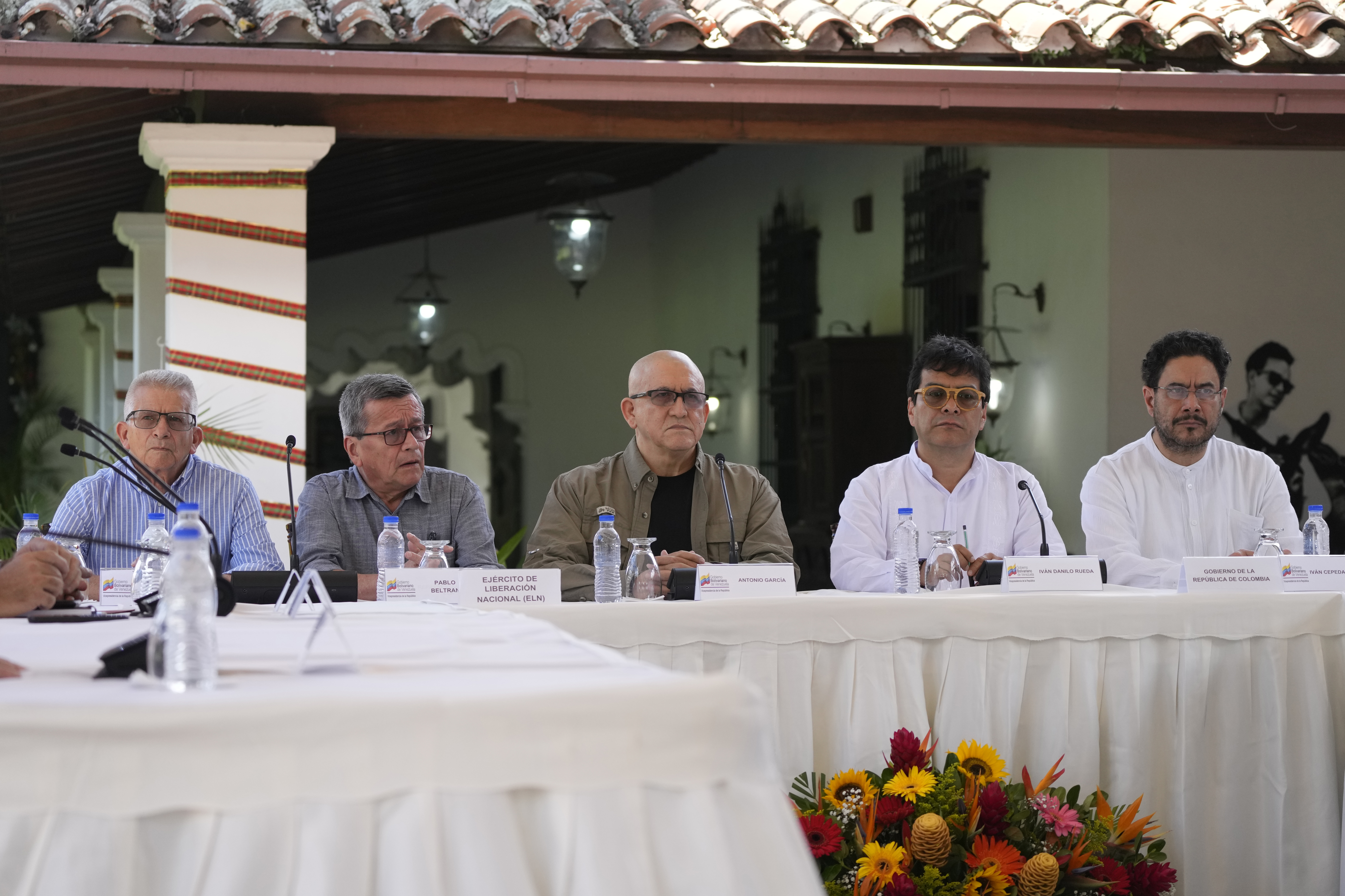 Members of the Colombian National Liberation Army (ELN), from left, Aureliano Carbonel, Pablo Beltran and Antonio Garcia sit with Ivan Danilo Rueda, high commissioner for peace on behalf of the Colombian government, second from right, and government representative Ivan Cepeda, during the signing ceremony agreeing to resume peace talks