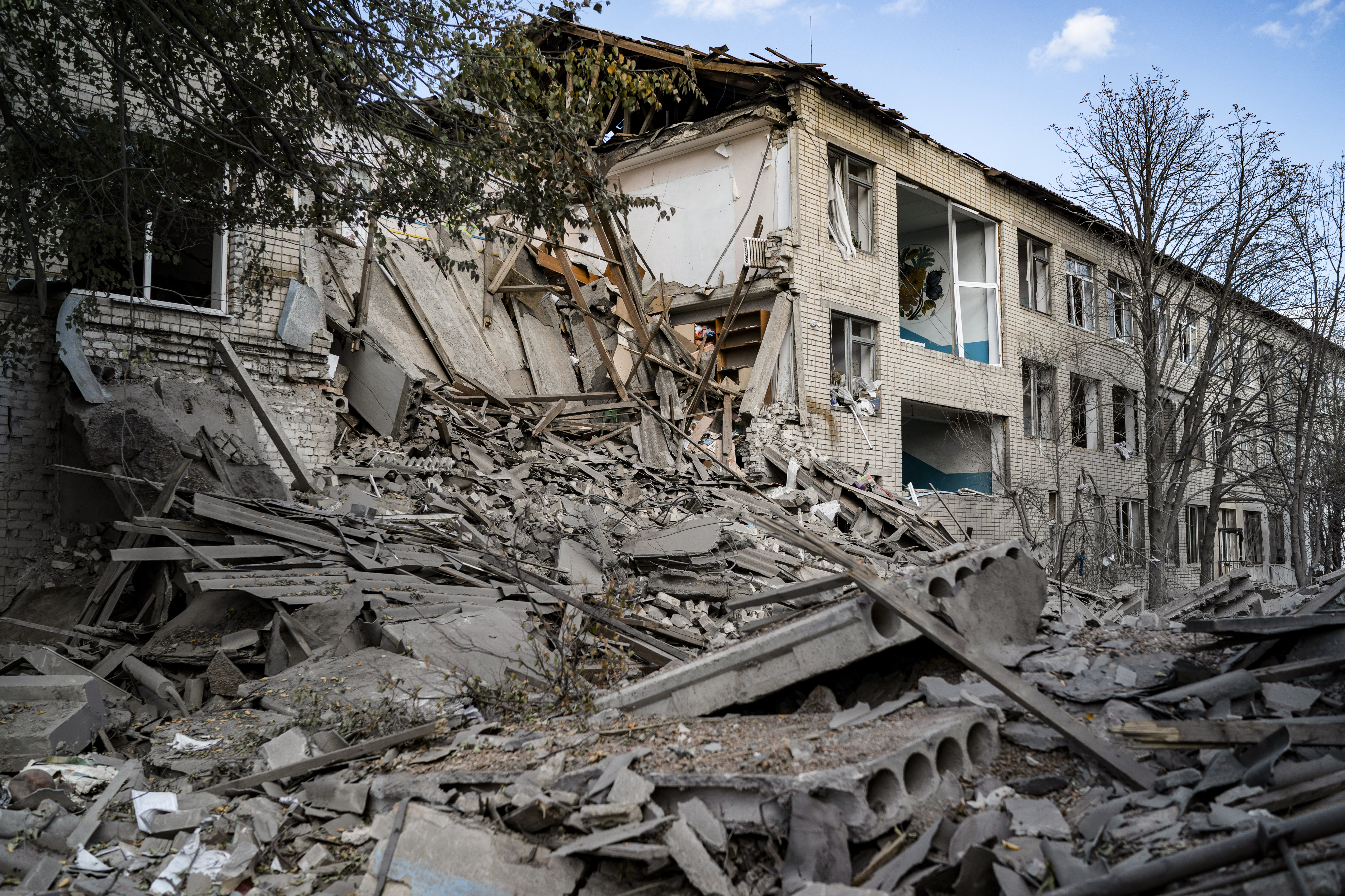 Debris covers an area of a heavily damaged school after a Russian attack, two days ago in the village of Velyka Kostromka, in Dnipropetrovsk region, Ukraine, on Thursday, October 13, 2022