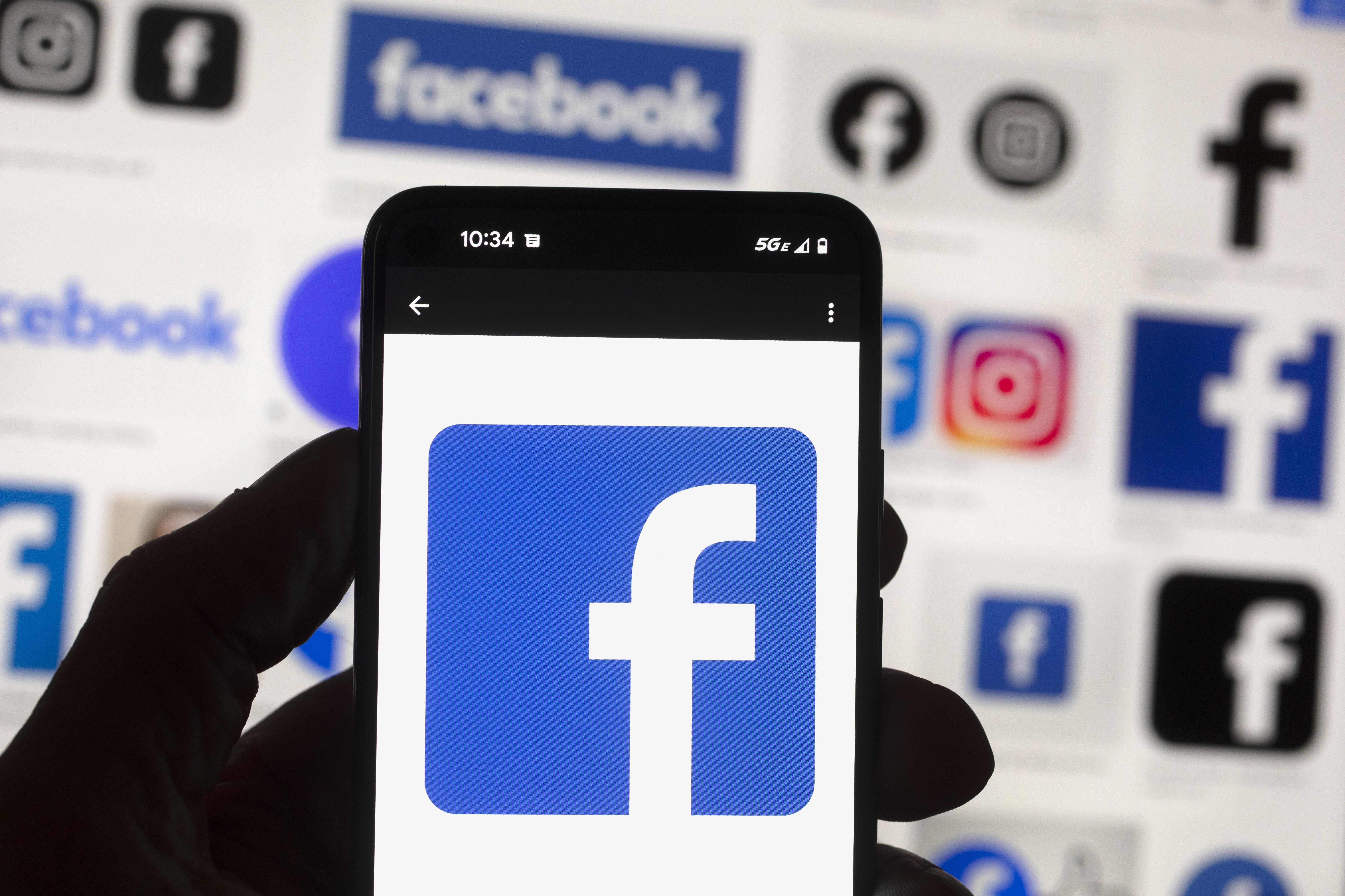 The Facebook logo is seen on a cell phone in Boston, US