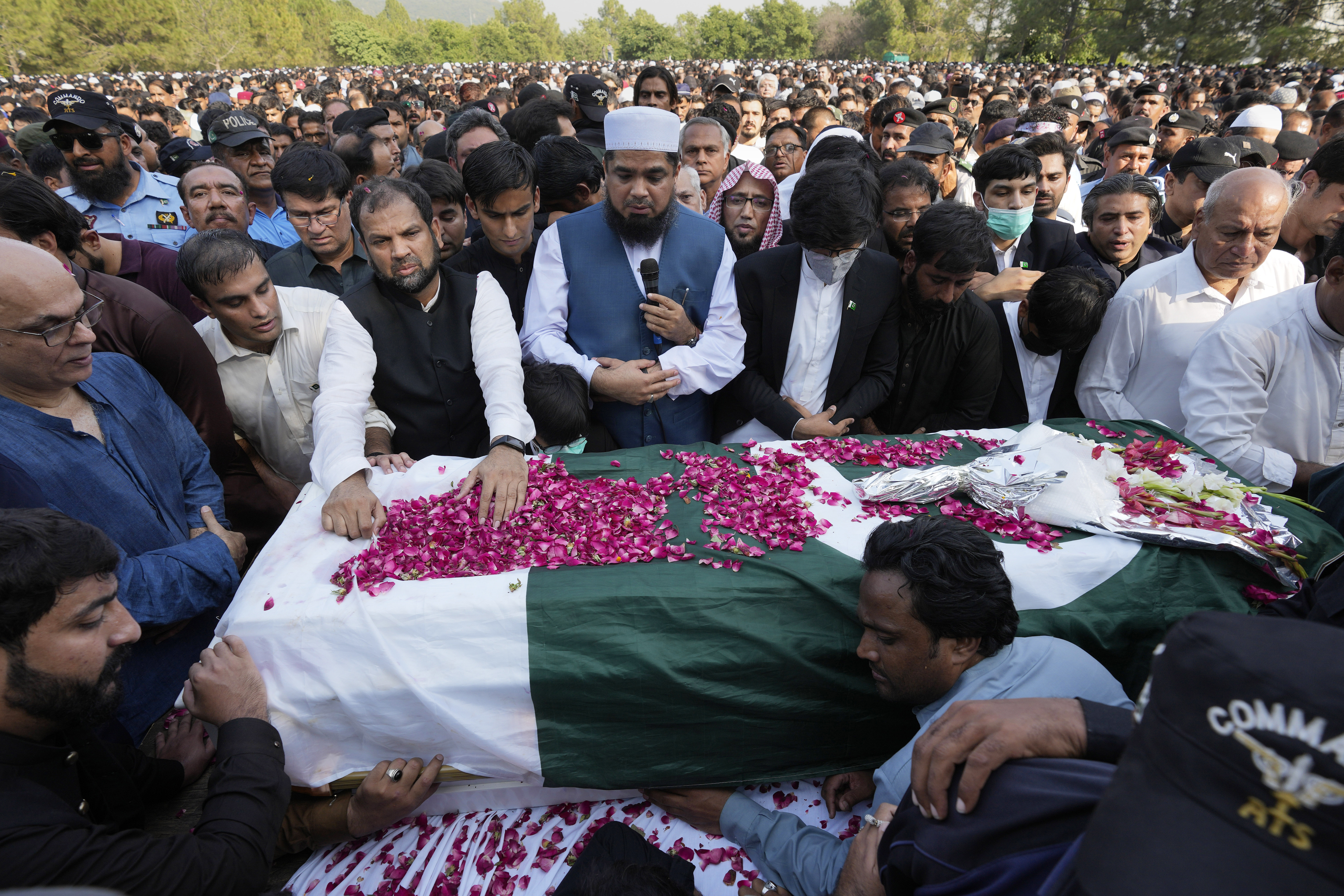 People attend the funeral prayer of slain senior Pakistani journalist Arshad Sharif, in Islamabad, Pakistan