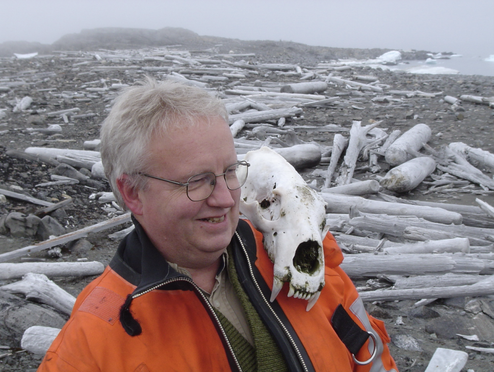 Braekkan balances a polar bear skull on his shoulder during one of his summer voyages to maintain weather stations in remote northeastern Svalbard [Courtesy of Ragnar Braekkan]