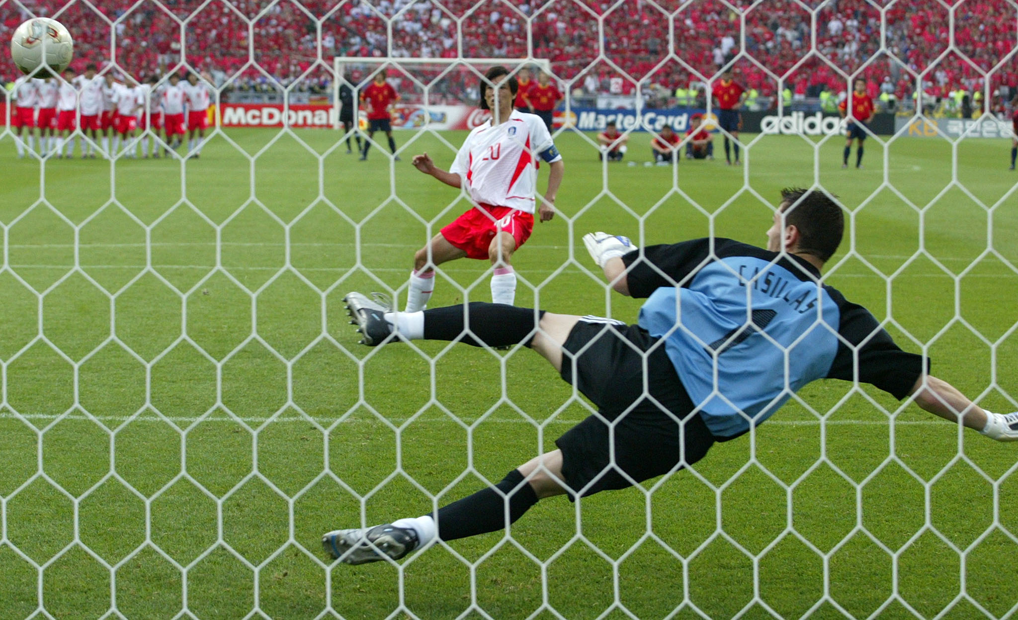 South Korea’s Hong Myung-bo scores the winning penalty past Spain’s Iker Casillas in their World Cup quarter-final penalty shootout in Kwangju, June 22, 2002