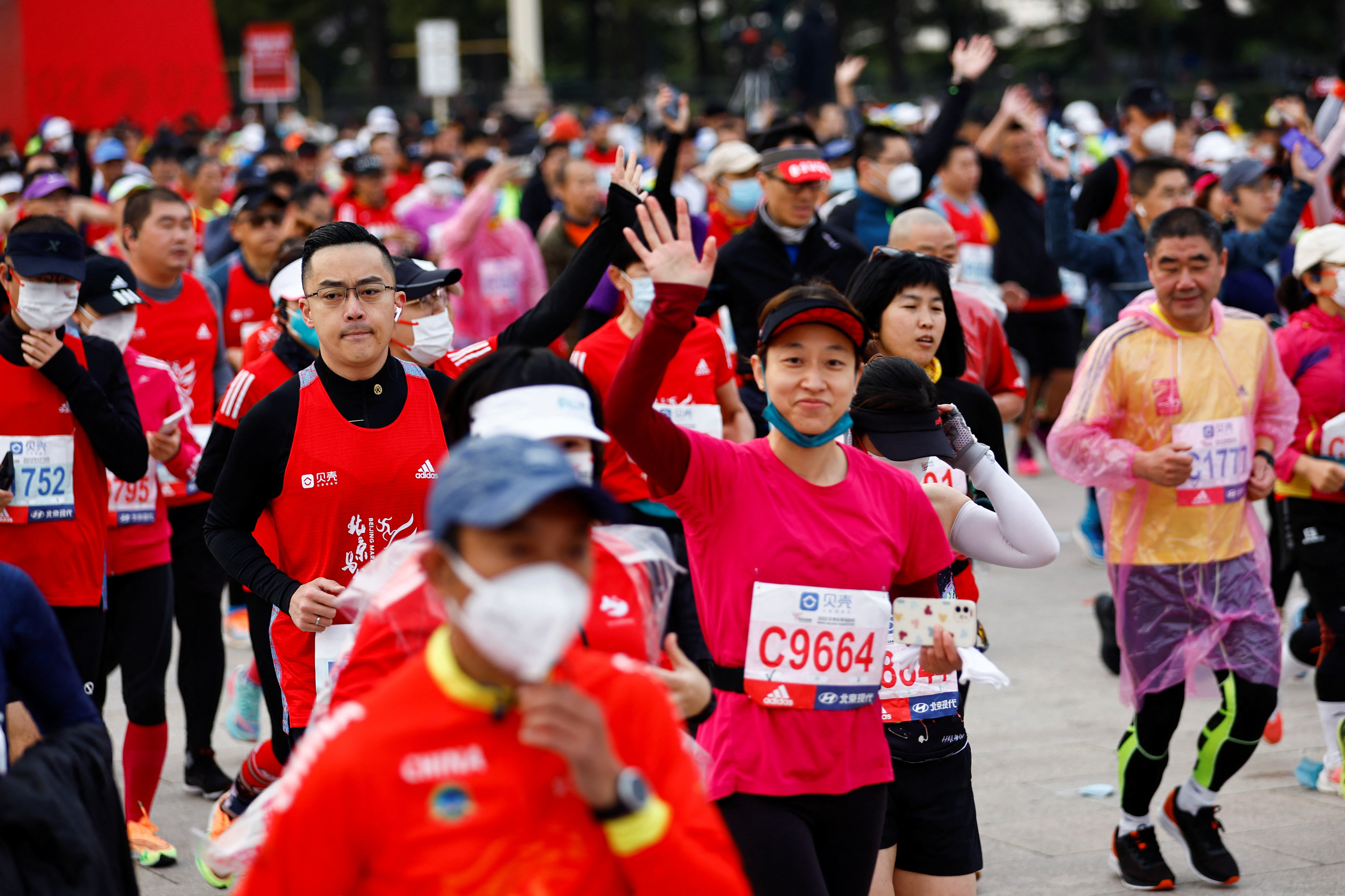 Participants wait before the Beijing Marathon, the first in two years