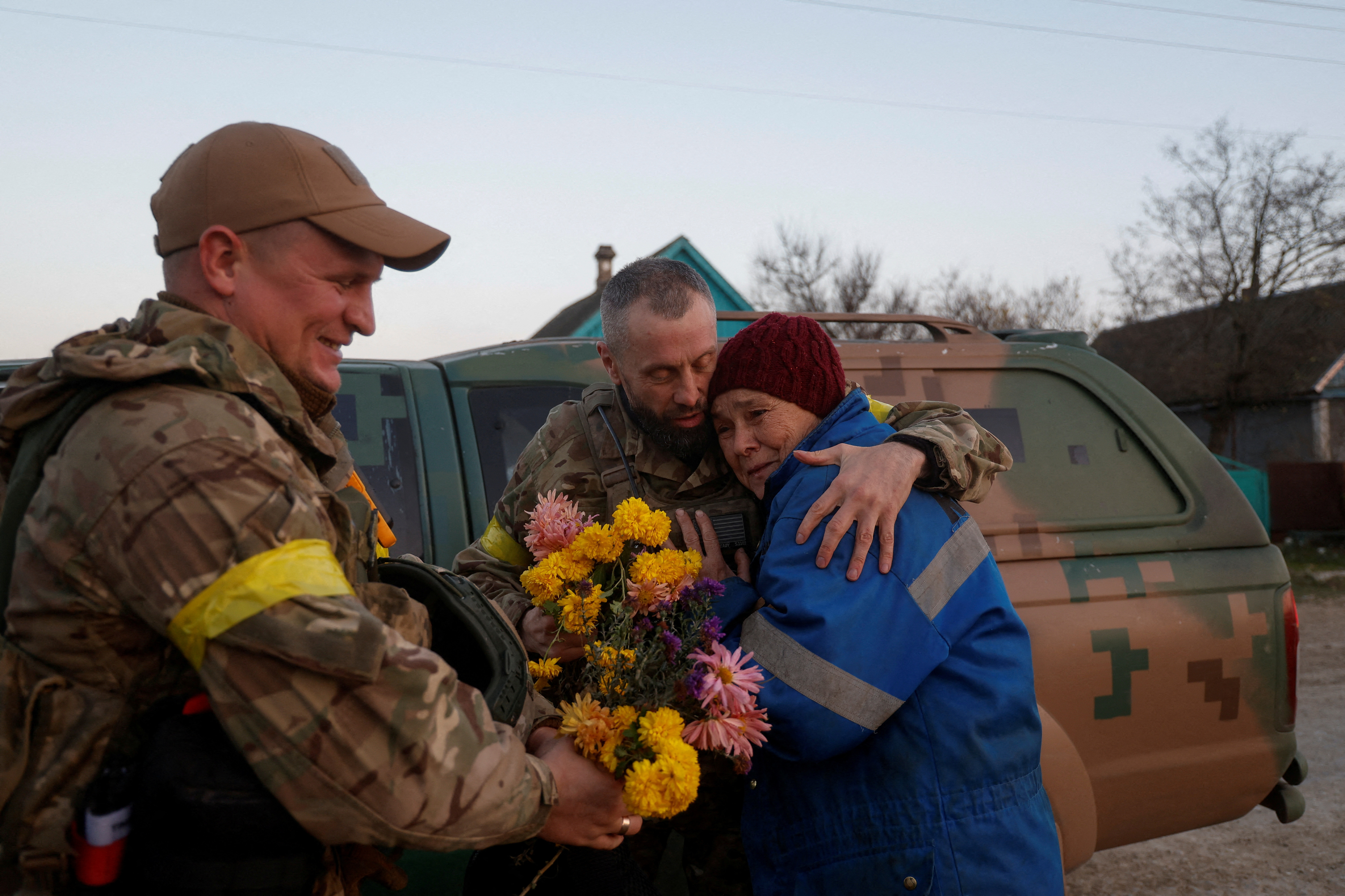 Local Valentyna Buhaiova embraces Ukrainian marines in the retaken village of Kyselivka, outside Kherson, Ukraine, November 12, 2022