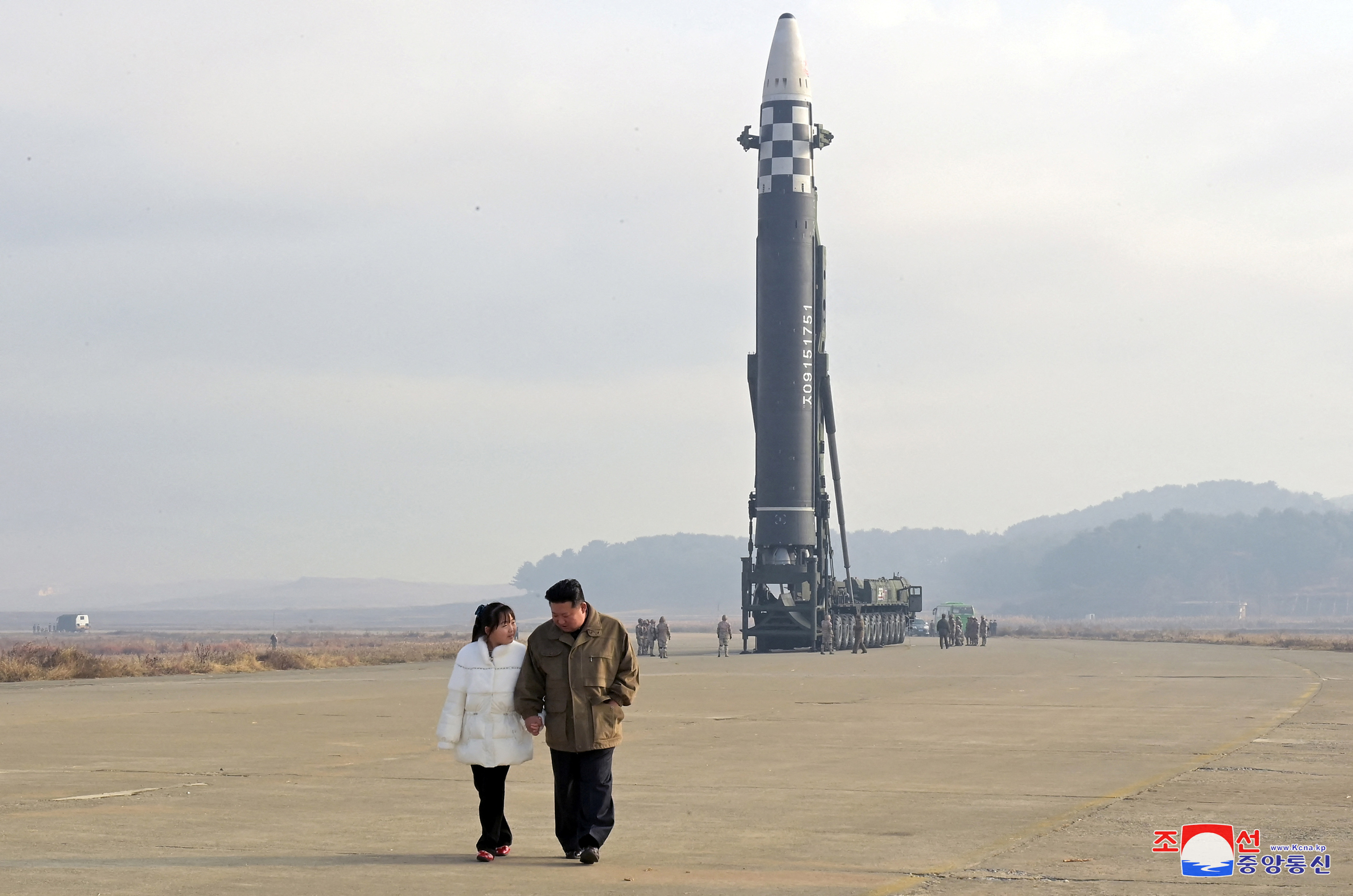 North Korean leader Kim Jong Un walks away from an intercontinental ballistic missile