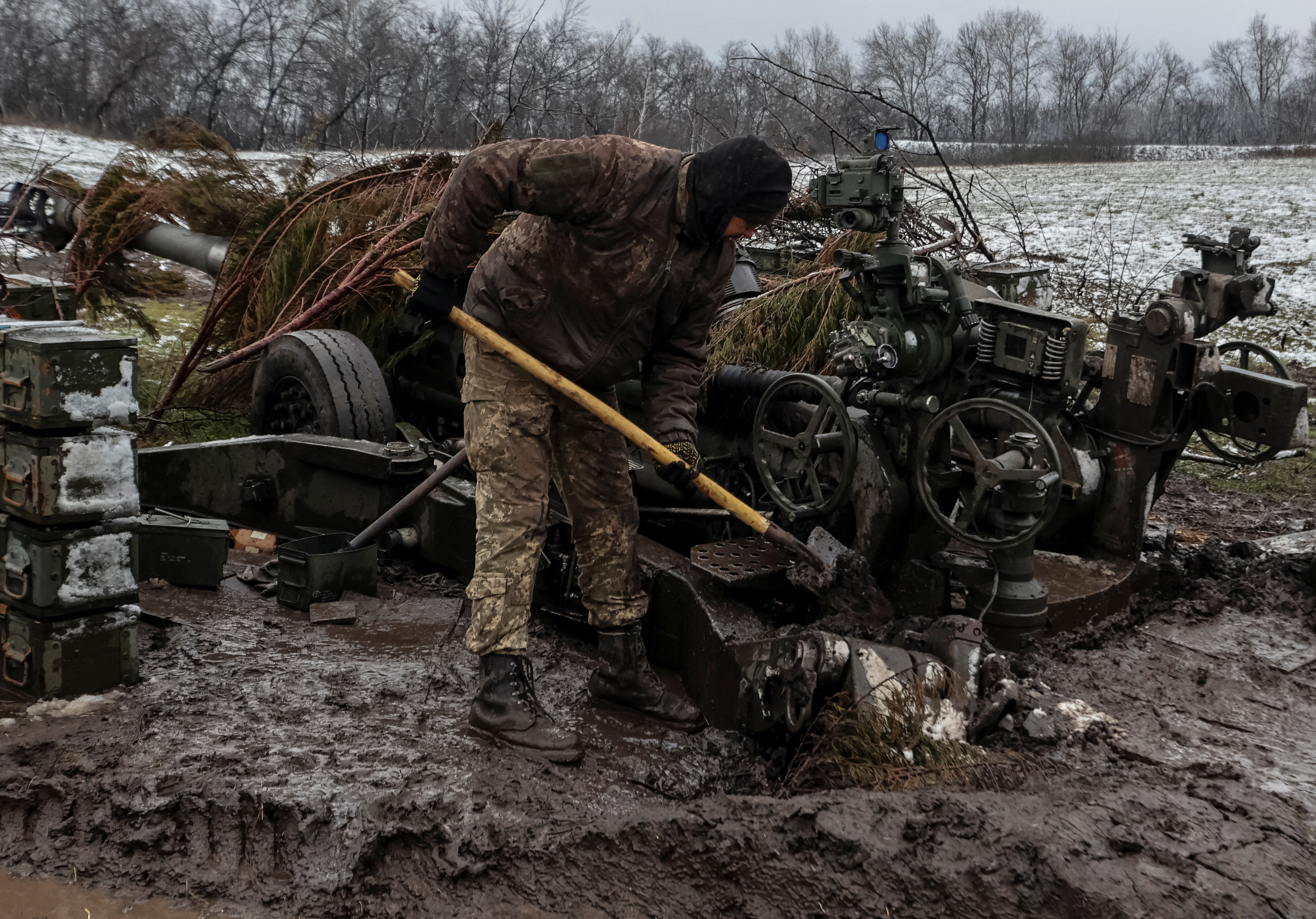 A Ukrainian service member works by an M777 Howitzer along the front line, as Russia’s attack on Ukraine continues, in Donetsk Region, Ukraine, on November 23, 2022