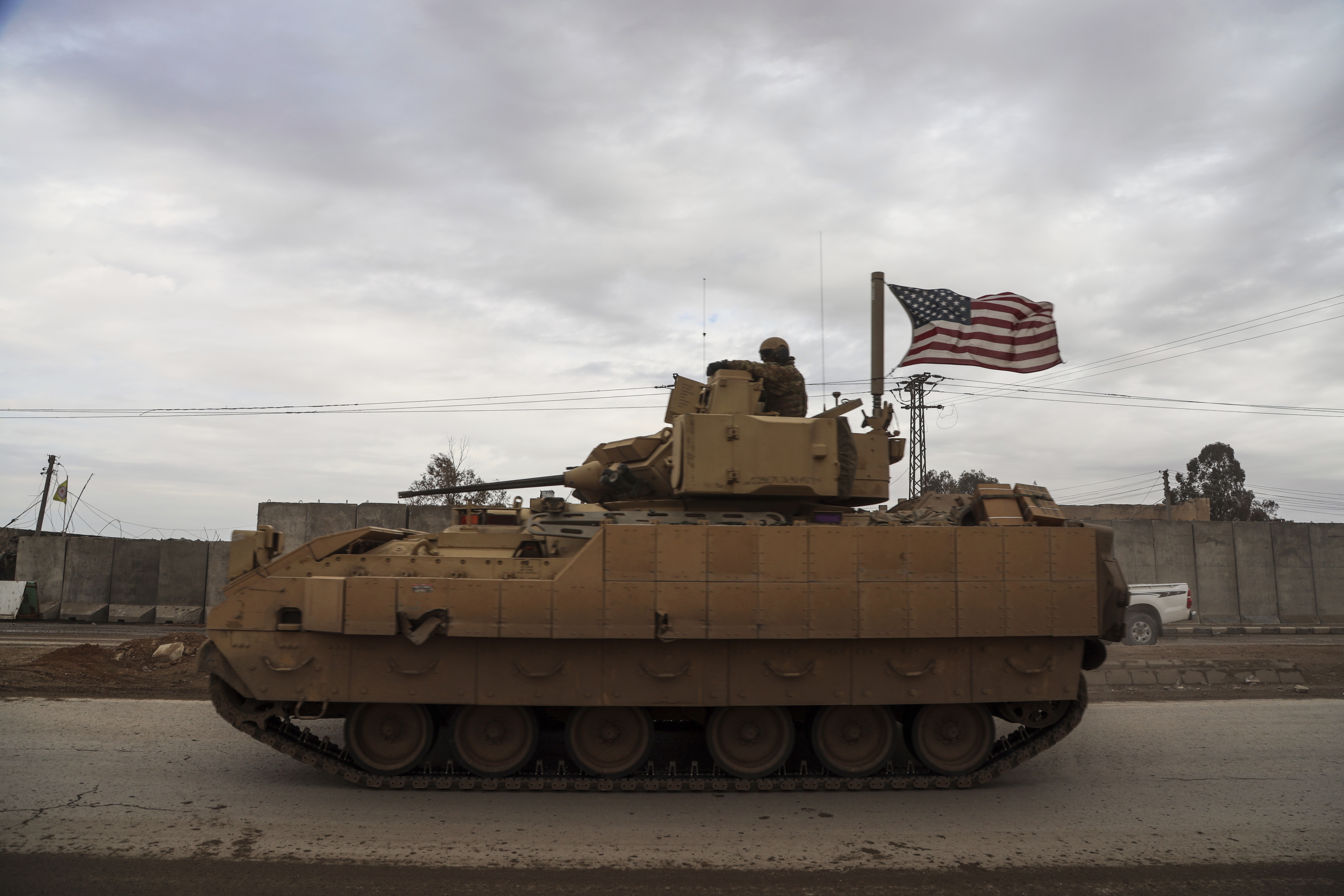 American soldiers patrol in a fighting vehicle near prison that was attacked by the Islamic Stete militants in Hassakeh, Syria
