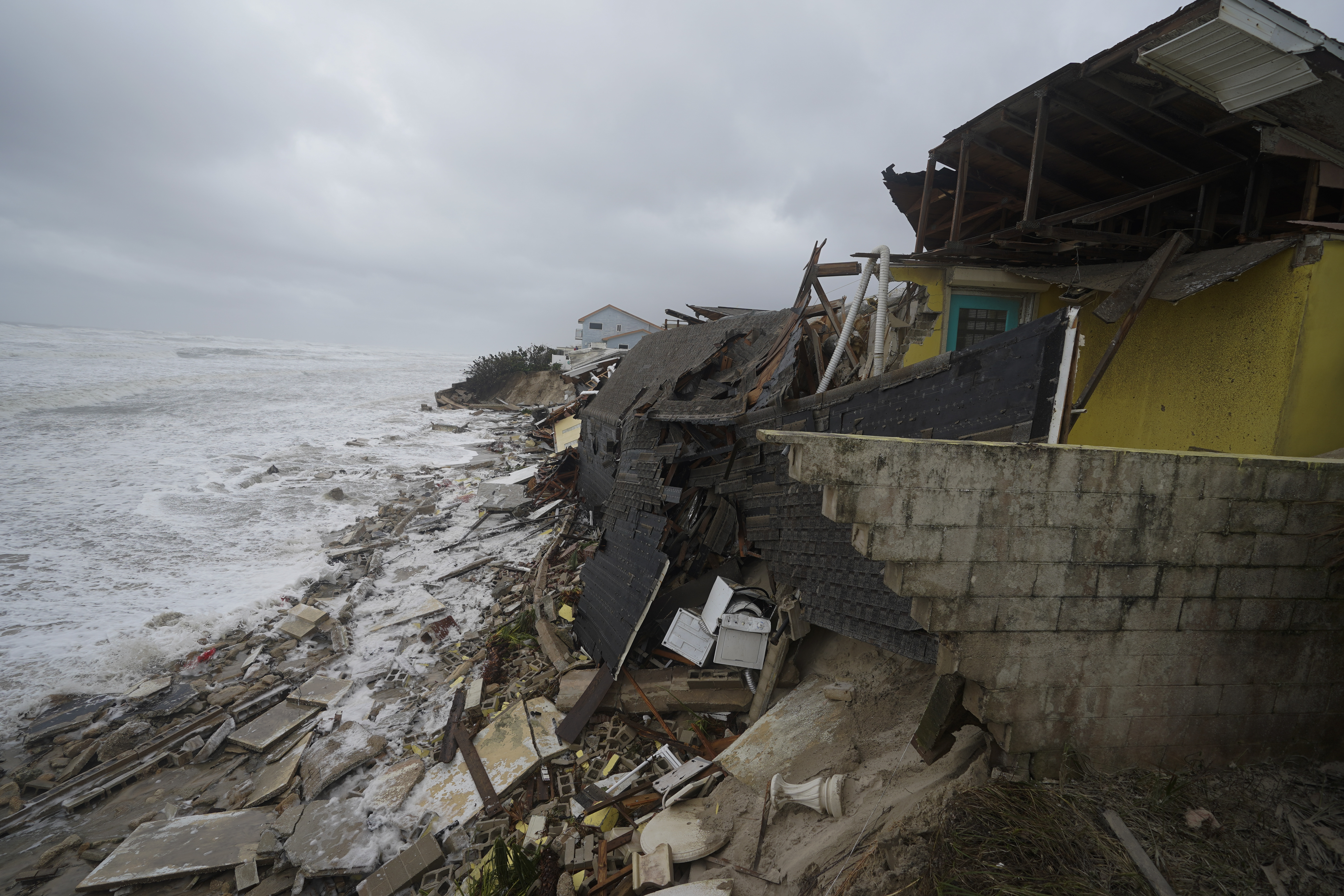 Parts of homes are seen collapsing on the beach due to the storm surge by Hurricane Nicole in Wilbur-By-The-Sea, on Florida’s mid-Atlantic coast.