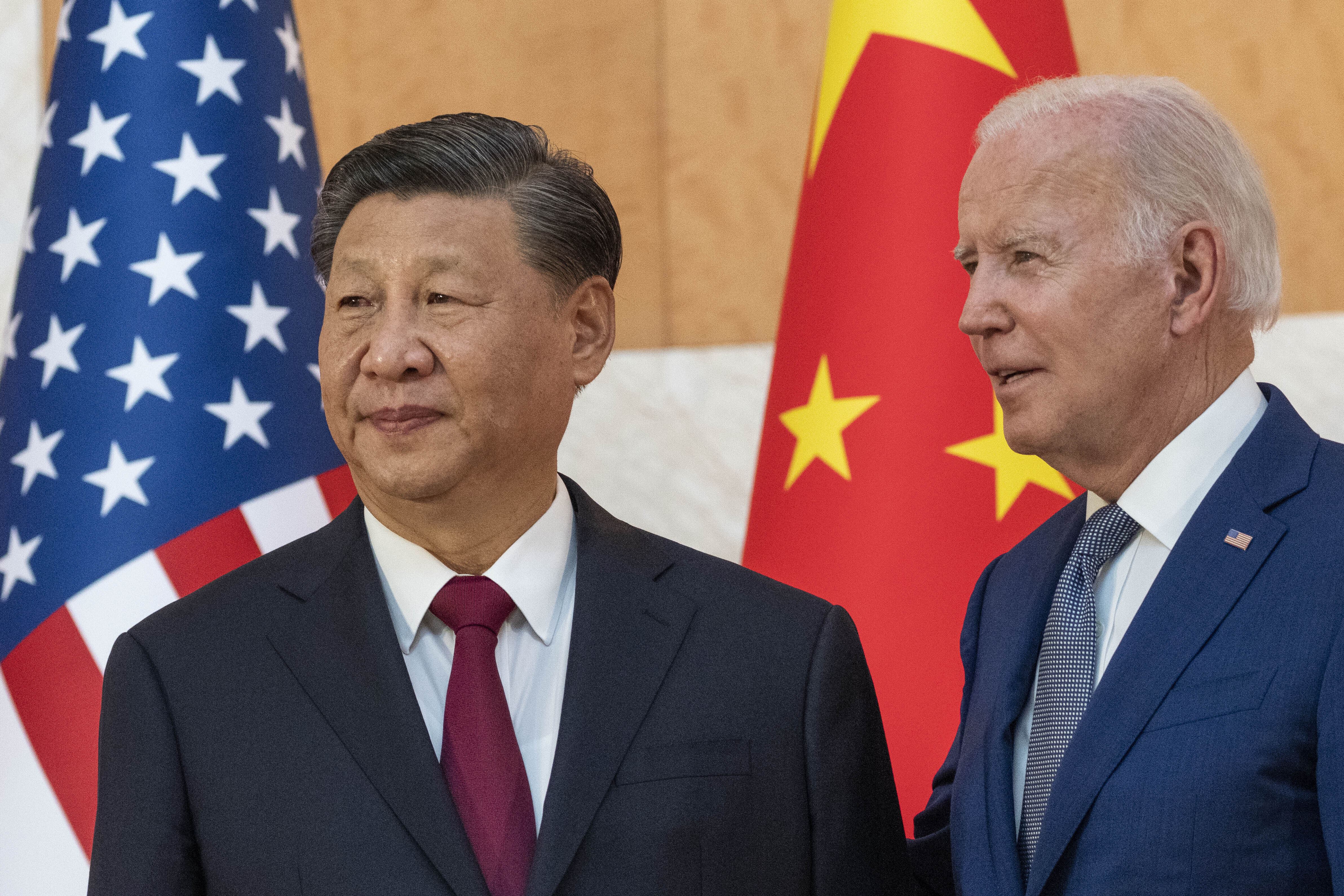 US President Joe Biden, right, stands with Chinese President Xi Jinping before a meeting on the sidelines of the G20 summit, November 14, 2022, in Bali, Indonesia