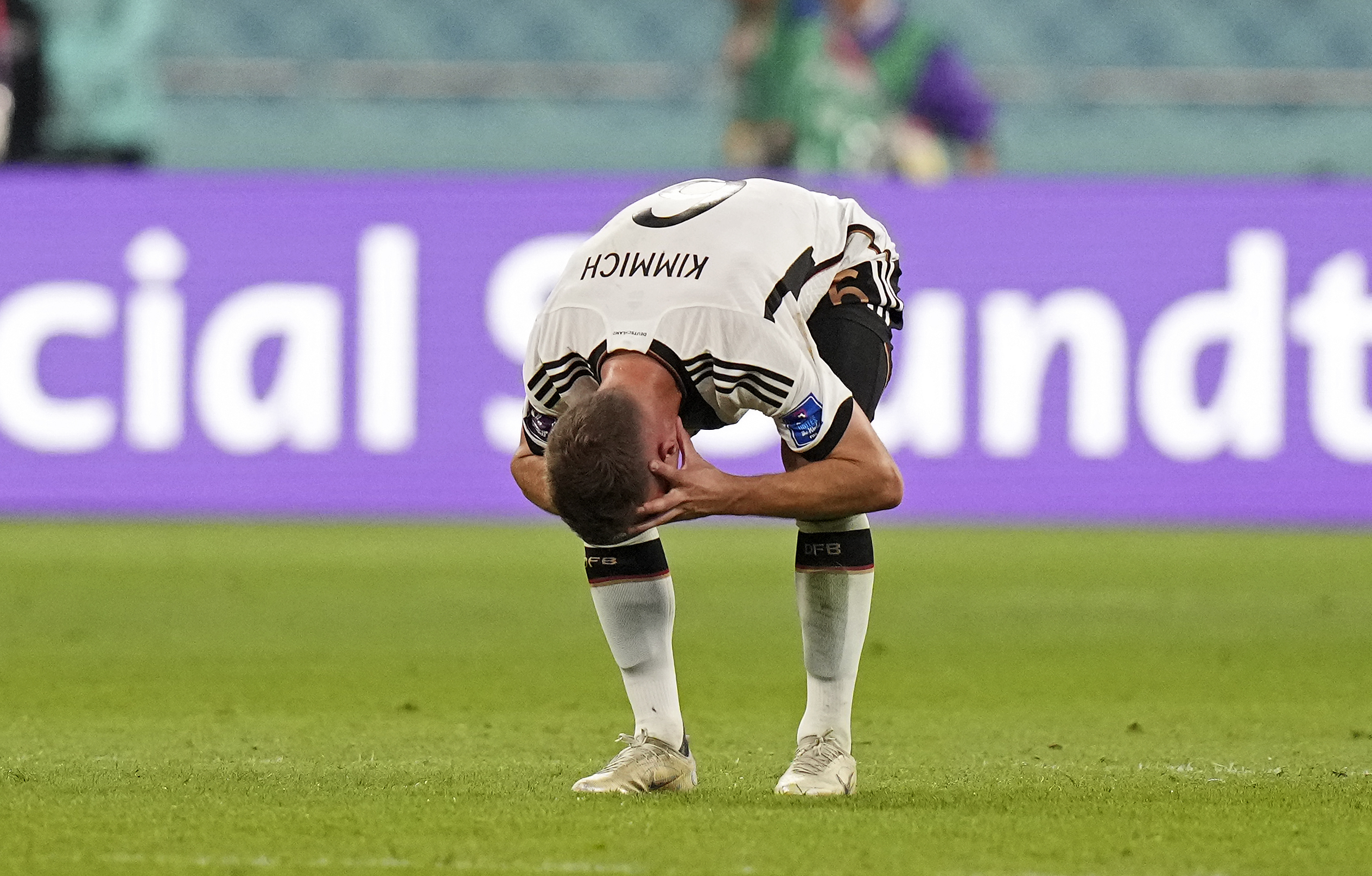 Germany’s Joshua Kimmich reacts after Japan scored during the World Cup group E football match between Germany and Japan, at the Khalifa International Stadium in Doha, Qatar, on November 23, 2022