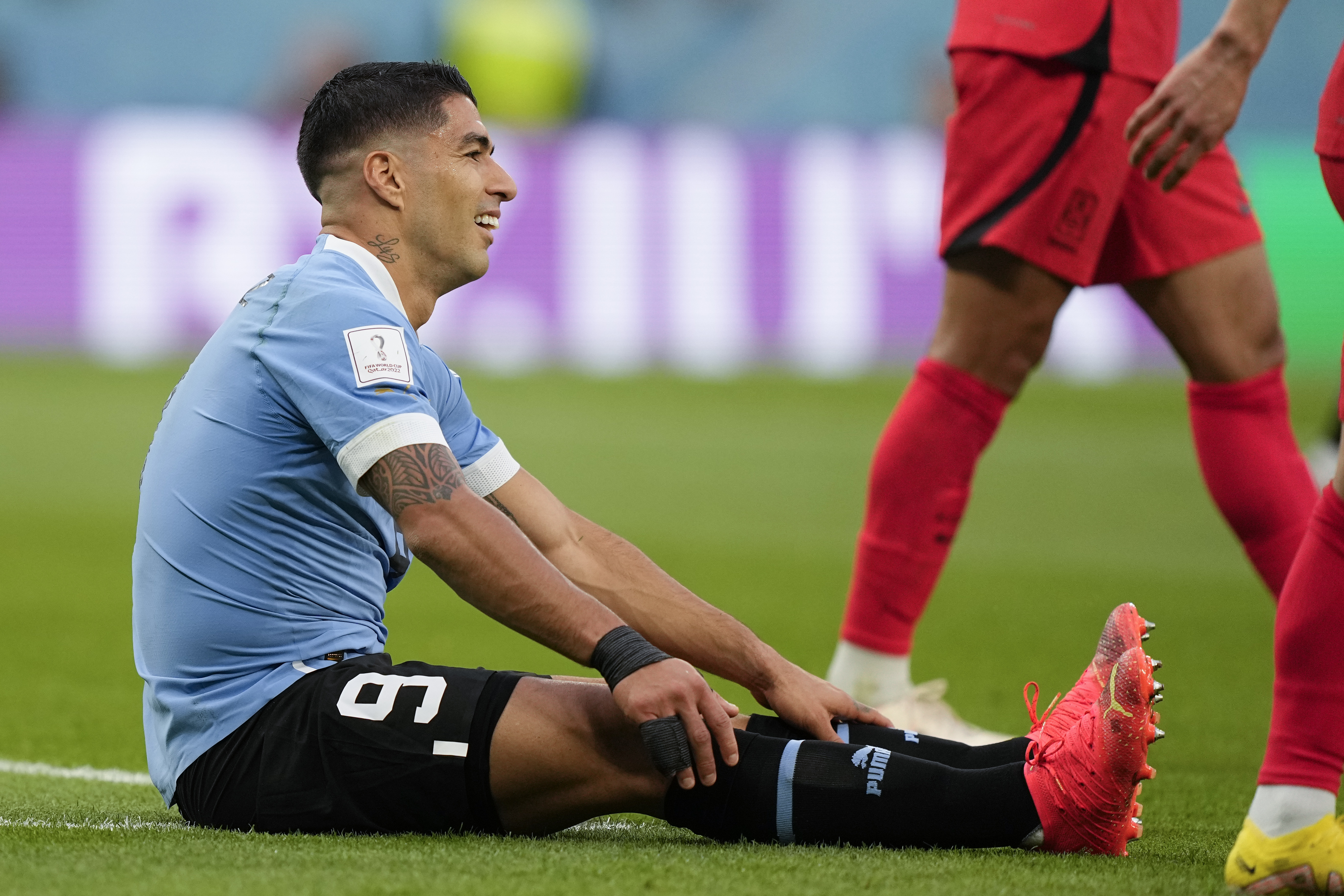 Uruguay’s Luis Suarez sits on the grass during the World Cup group H match against South Korea, at the Education City Stadium in Al Rayyan, Qatar, November 24, 2022